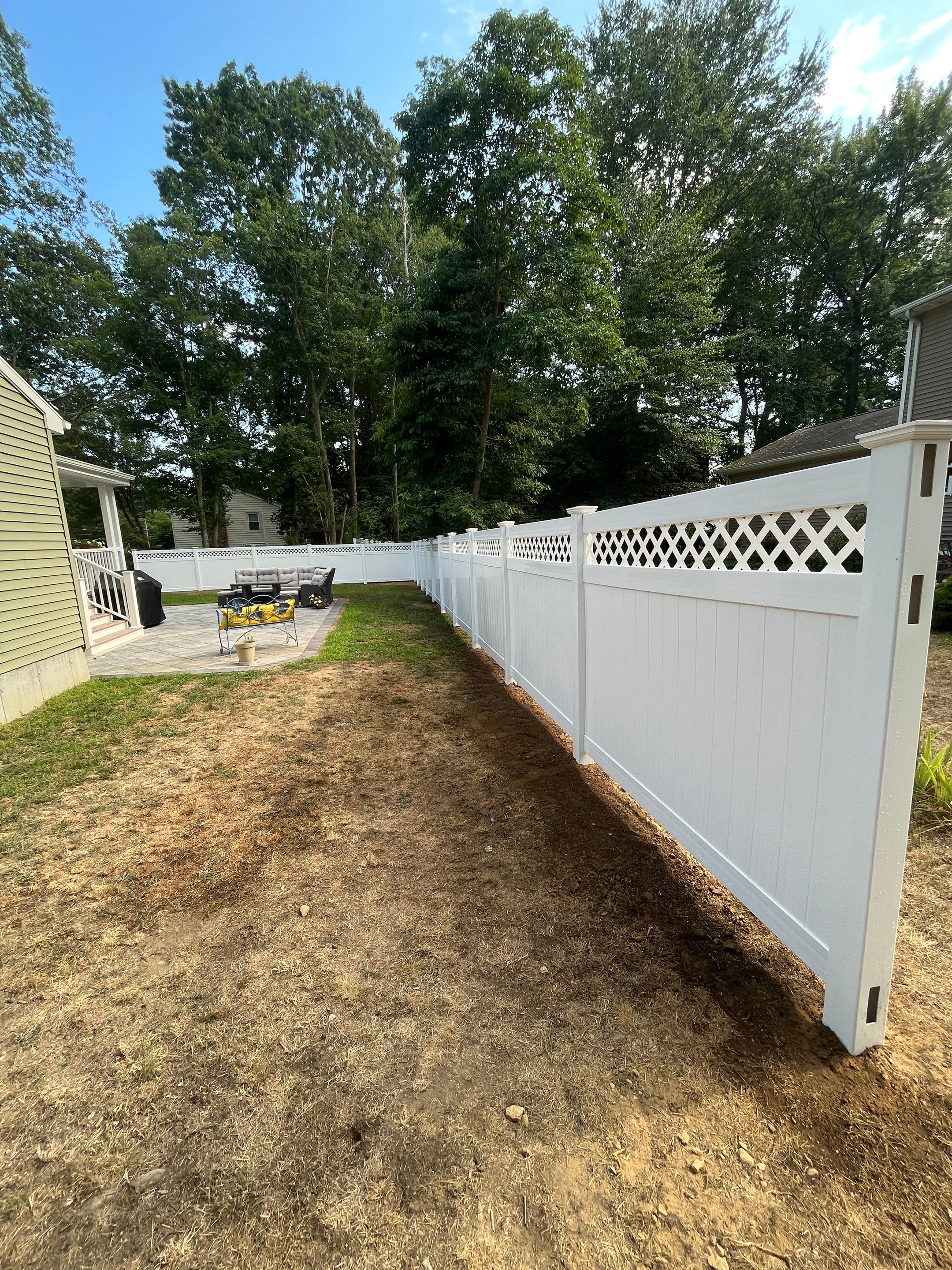 Vinyl privacy fence with Lattice top, White  by DiGiorgi Roofing and Siding Inc