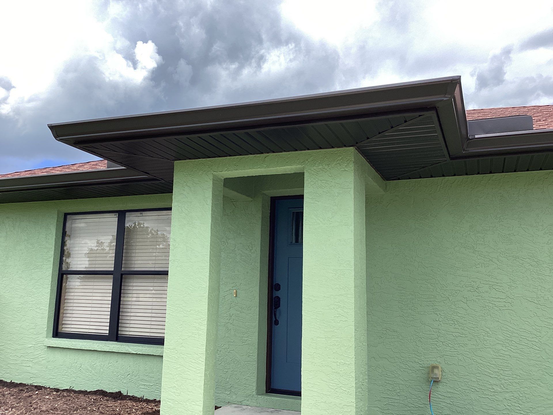 Musket brown downspouts with 6-inch K-Style gutter installation in Myakka City, FL by Gutter Professors