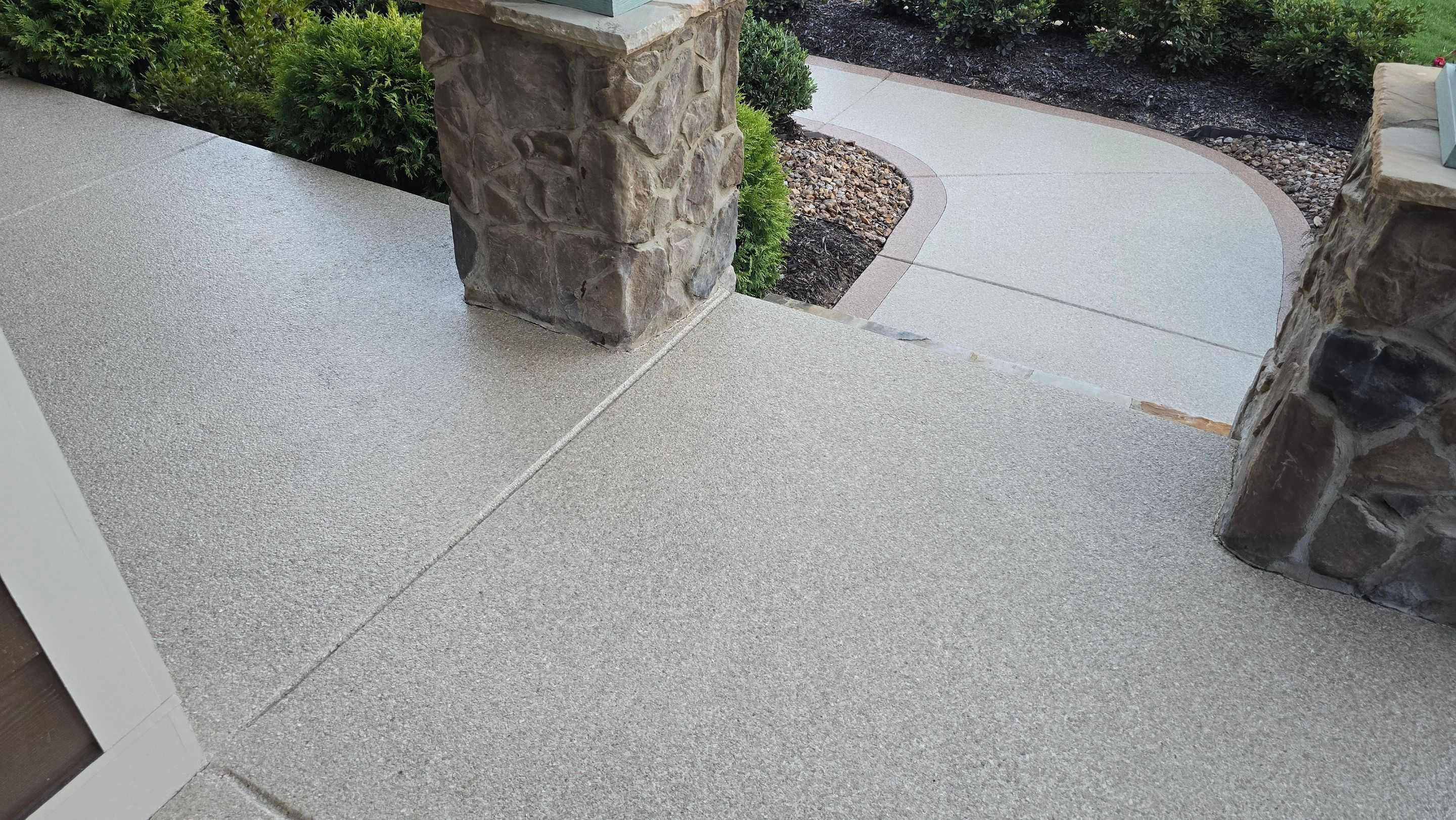 Driveway and sidewalk using Feldspar with the border done in Spilite by Elite Floor Solutions