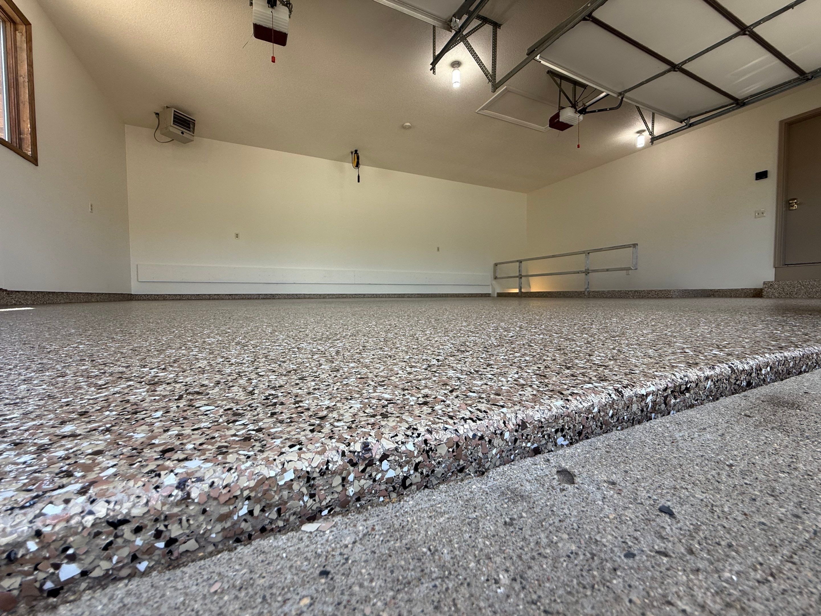 Custom Polyaspartic Garage Floor and Stairwell Coating in Pipestone by Select Painting, Coatings & Garage Cabinets