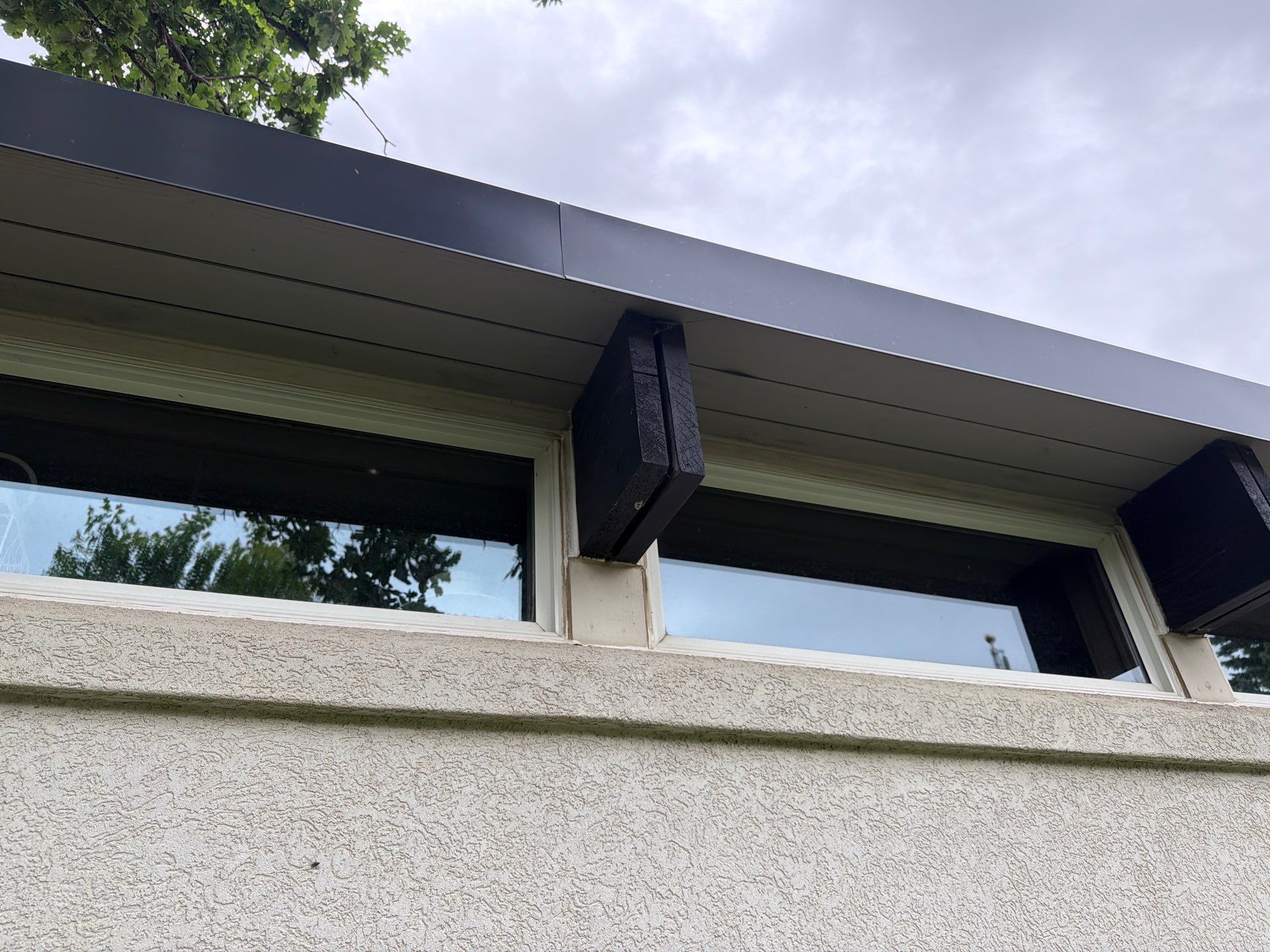 Exterior Trim Painting and Rafter Staining in Sioux Falls by Select Painting, Coatings & Garage Cabinets