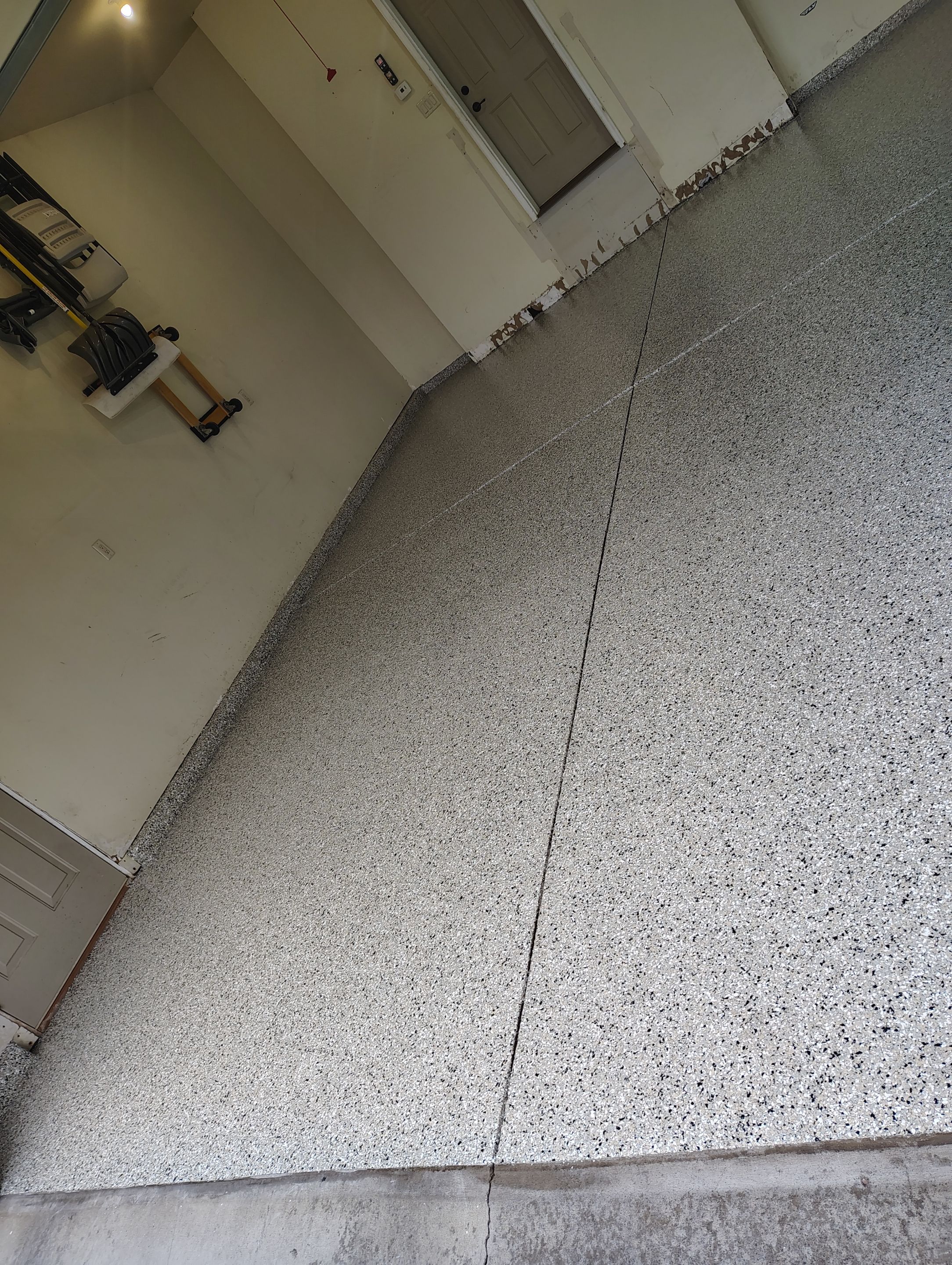 Sioux Falls Garage Floor Repair and Speckled Epoxy Coating Installation by Select Painting, Coatings & Garage Cabinets