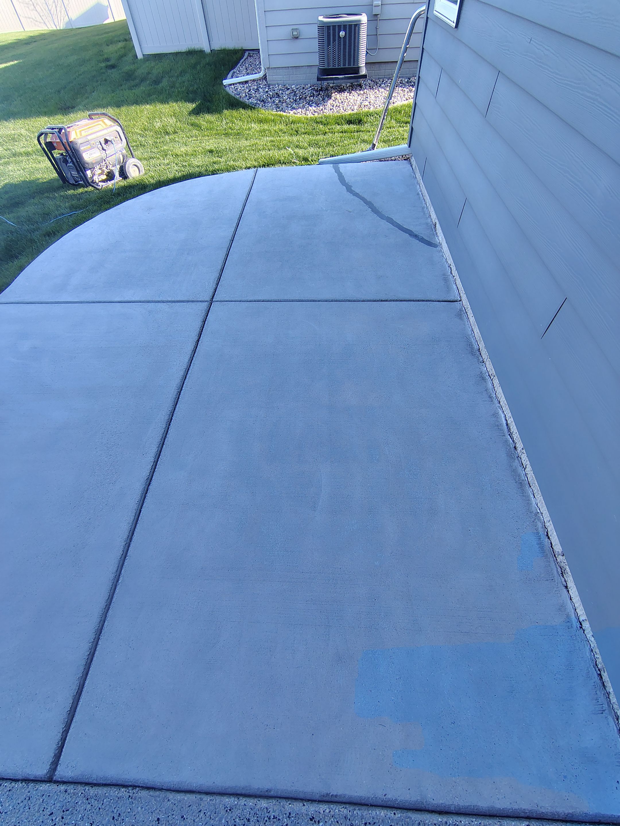 Speckled Concrete Patio Coating Installation in Sioux Falls by Select Painting, Coatings & Garage Cabinets