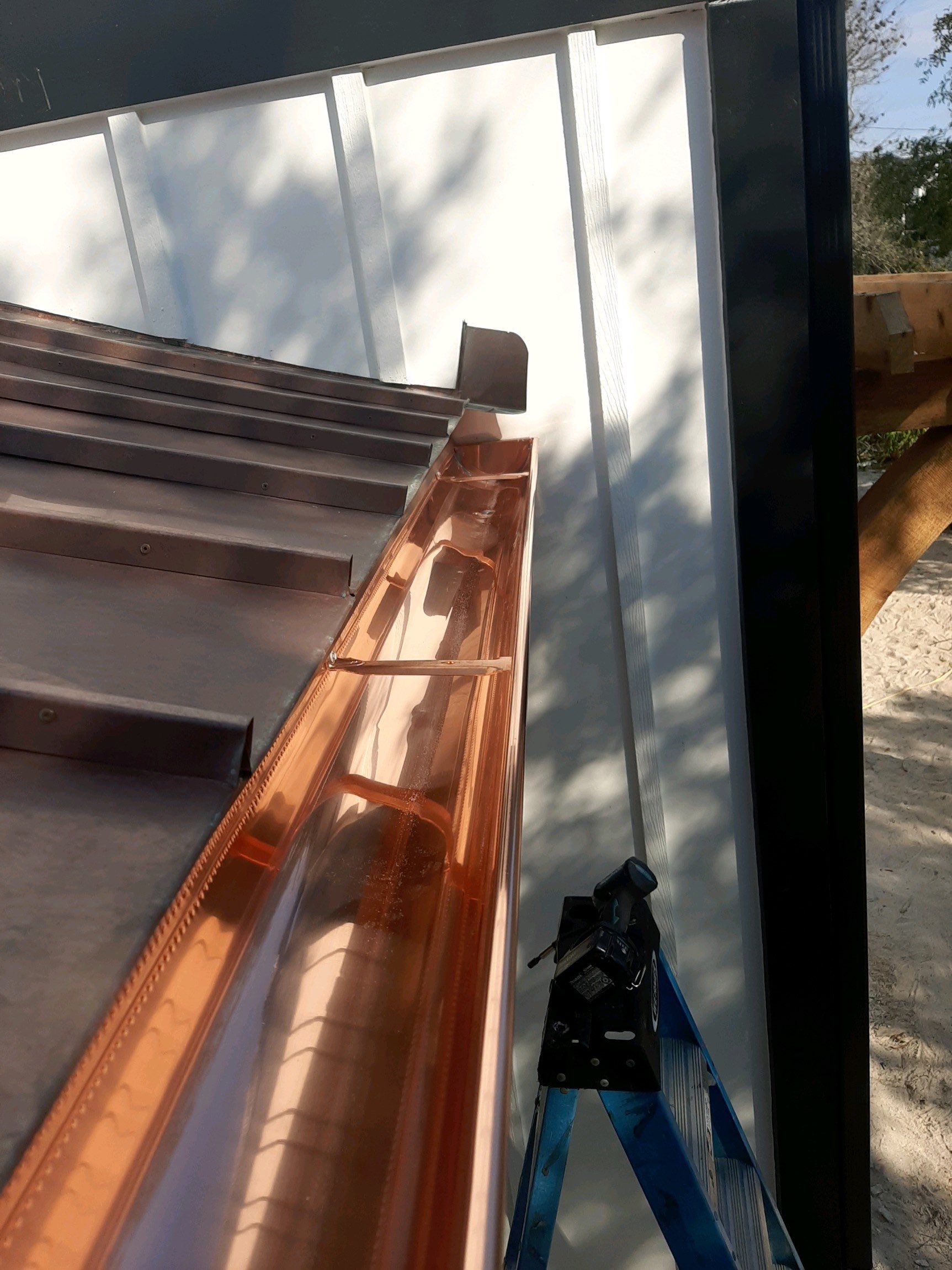 Seamless Gutter Installation Using Black Half Round Seamless Gutters by Gutter Professors