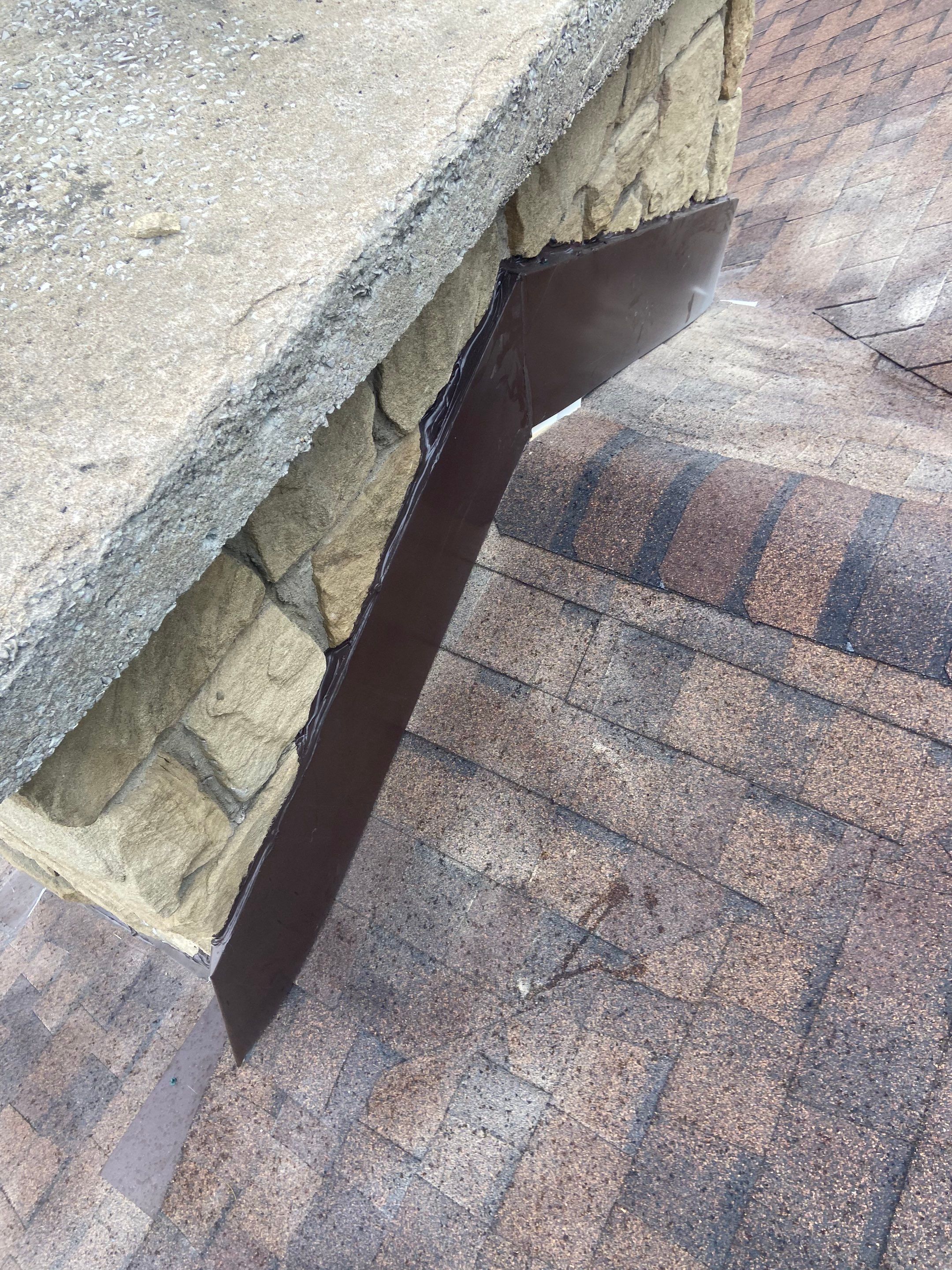 Shingle Roofing with Velux Skylight replacement and stone chimney flashing  by Secure Construction Company Inc