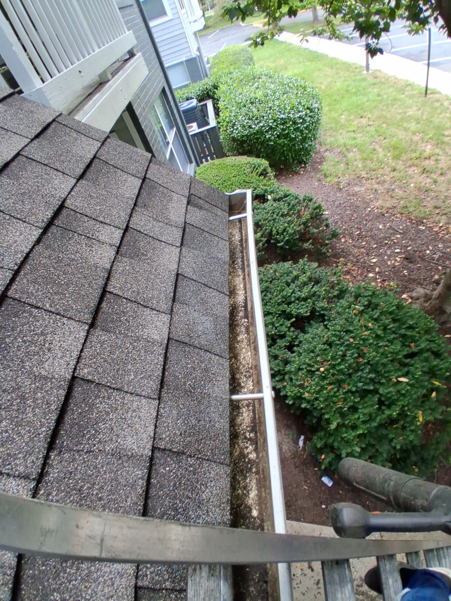 HOA gutter cleaning in Bowie & Largo, MD, after  photo showing full gutters.