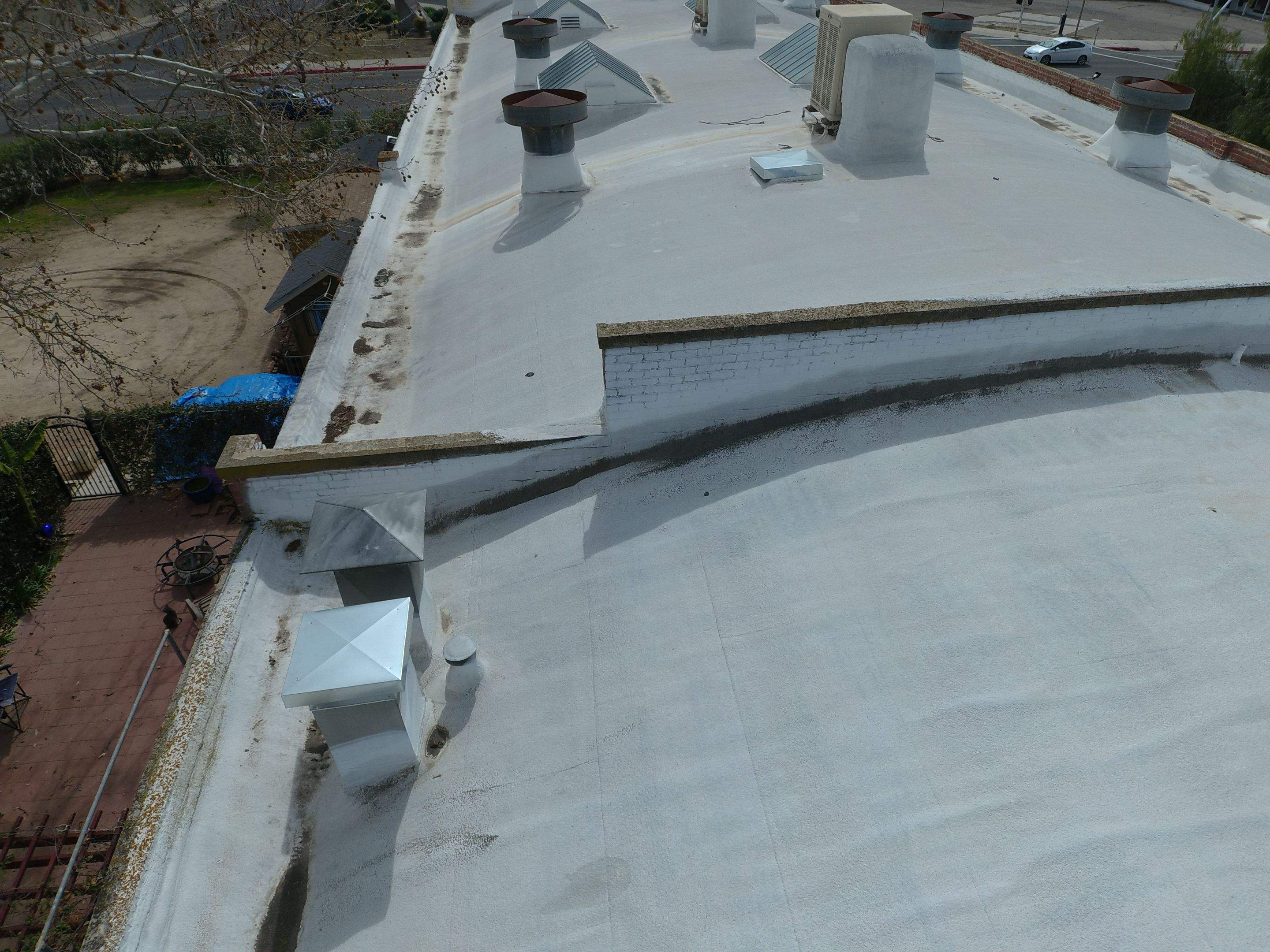 Polyurethane foam roof refurbish and recoating by Straight Edge Roofing Inc