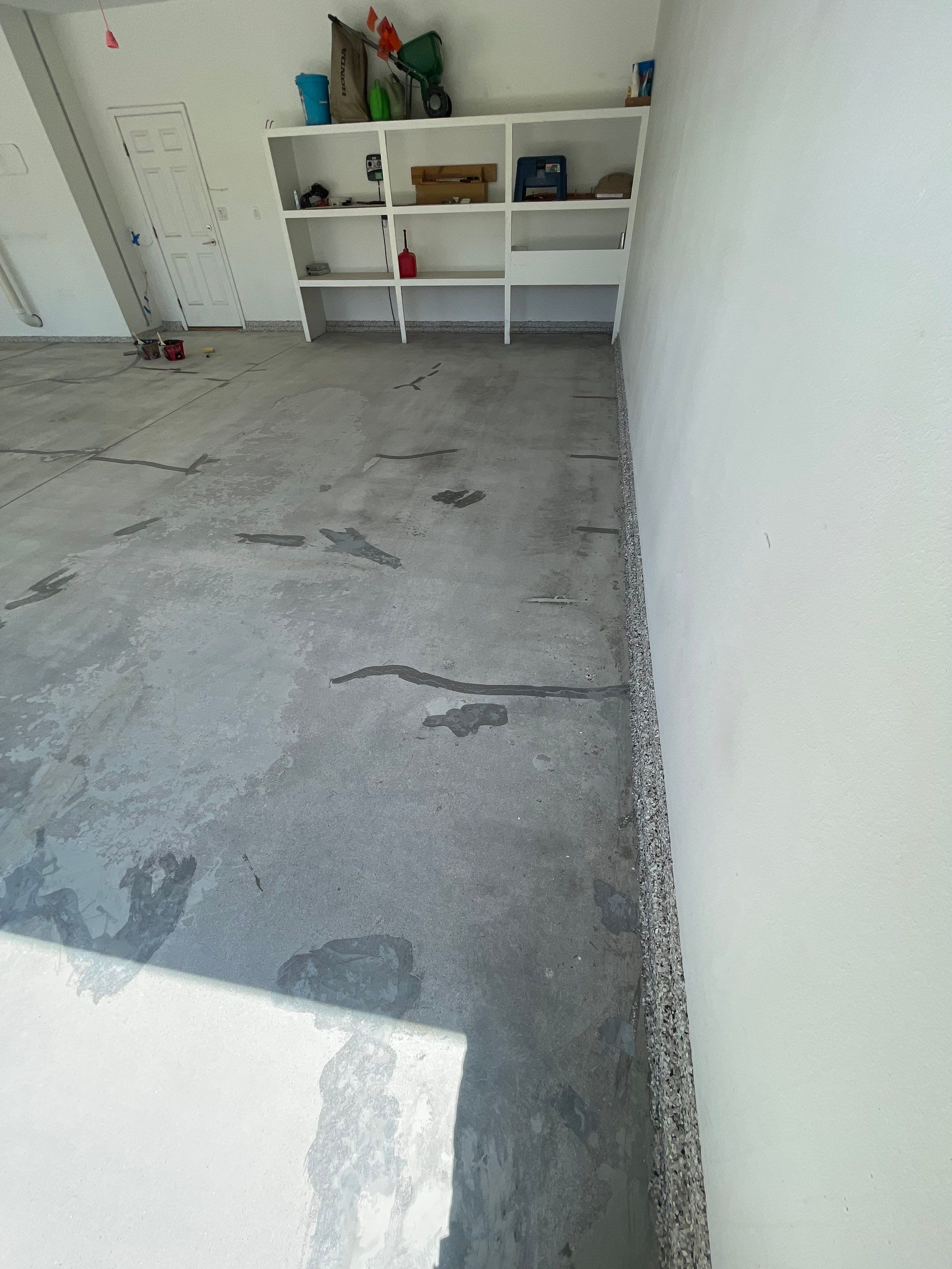 Yankton Garage Floor Restoration with Gray Speckled Epoxy Coating by Select Painting, Coatings & Garage Cabinets