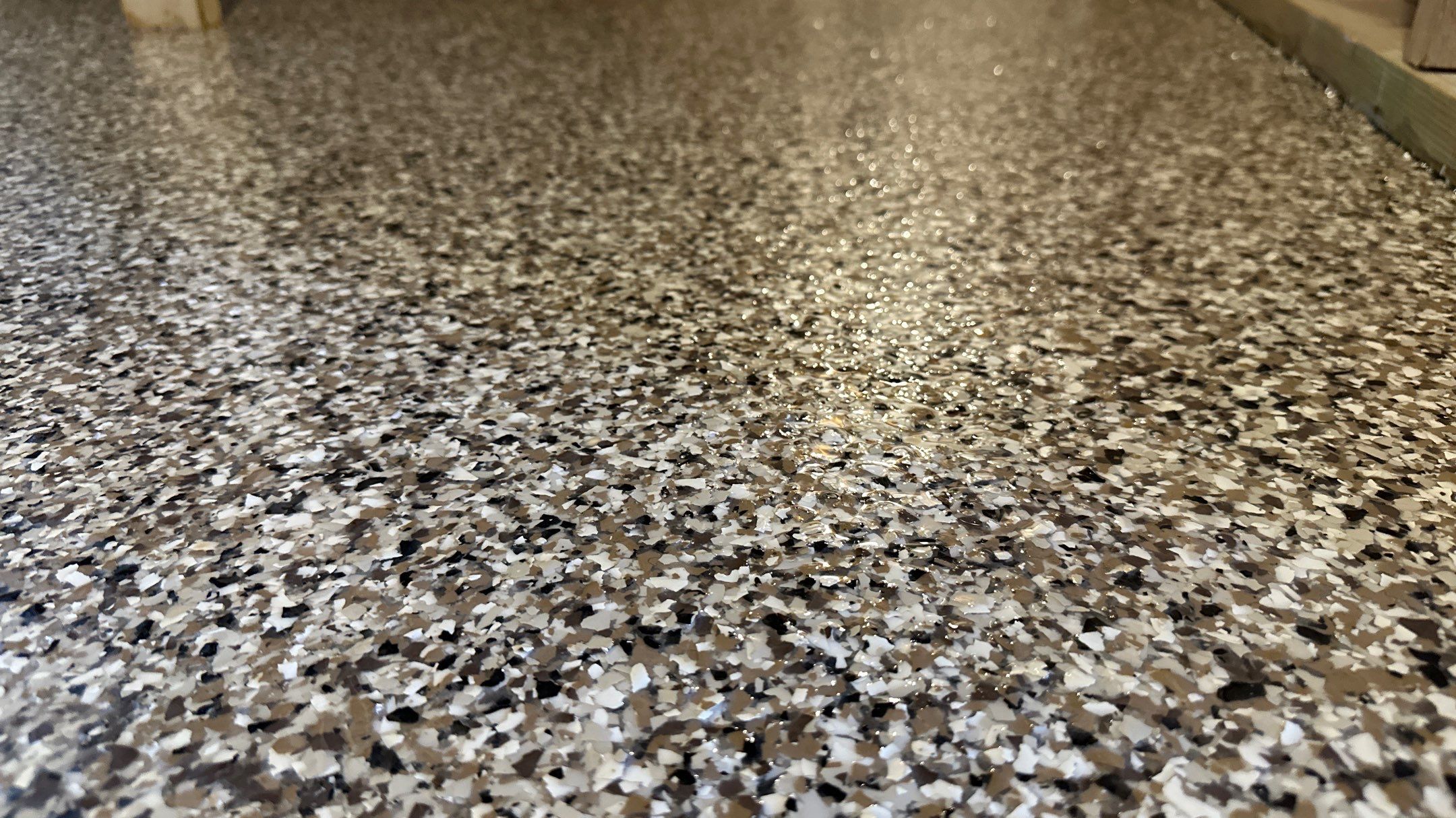 Shelly E. chose a riverbed flake floor for their basement  by Banner Garage