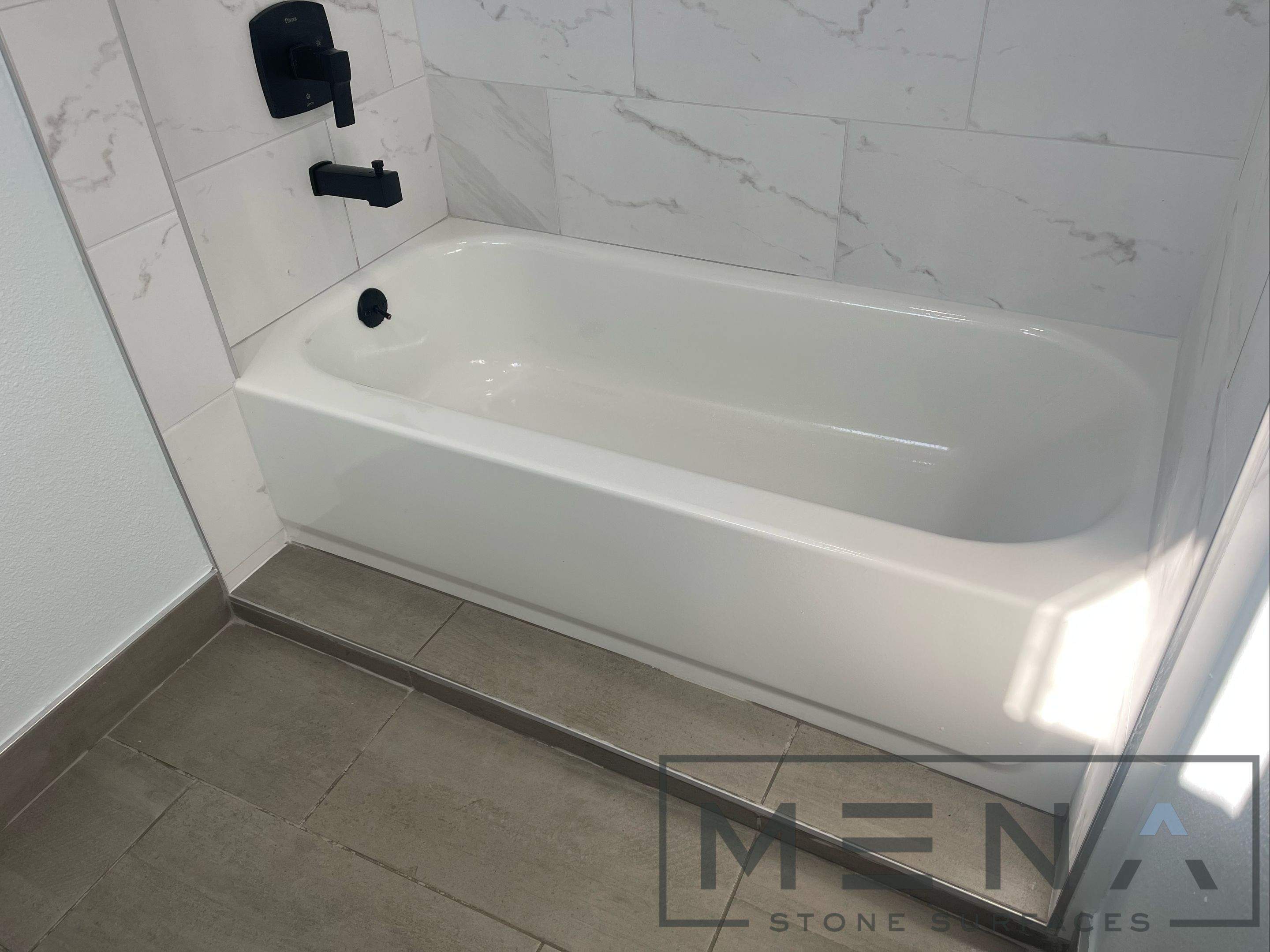 Complete Bathroom Remodel Featuring Marble Tile and Teal Herringbone Niche by Mena stone surfaces