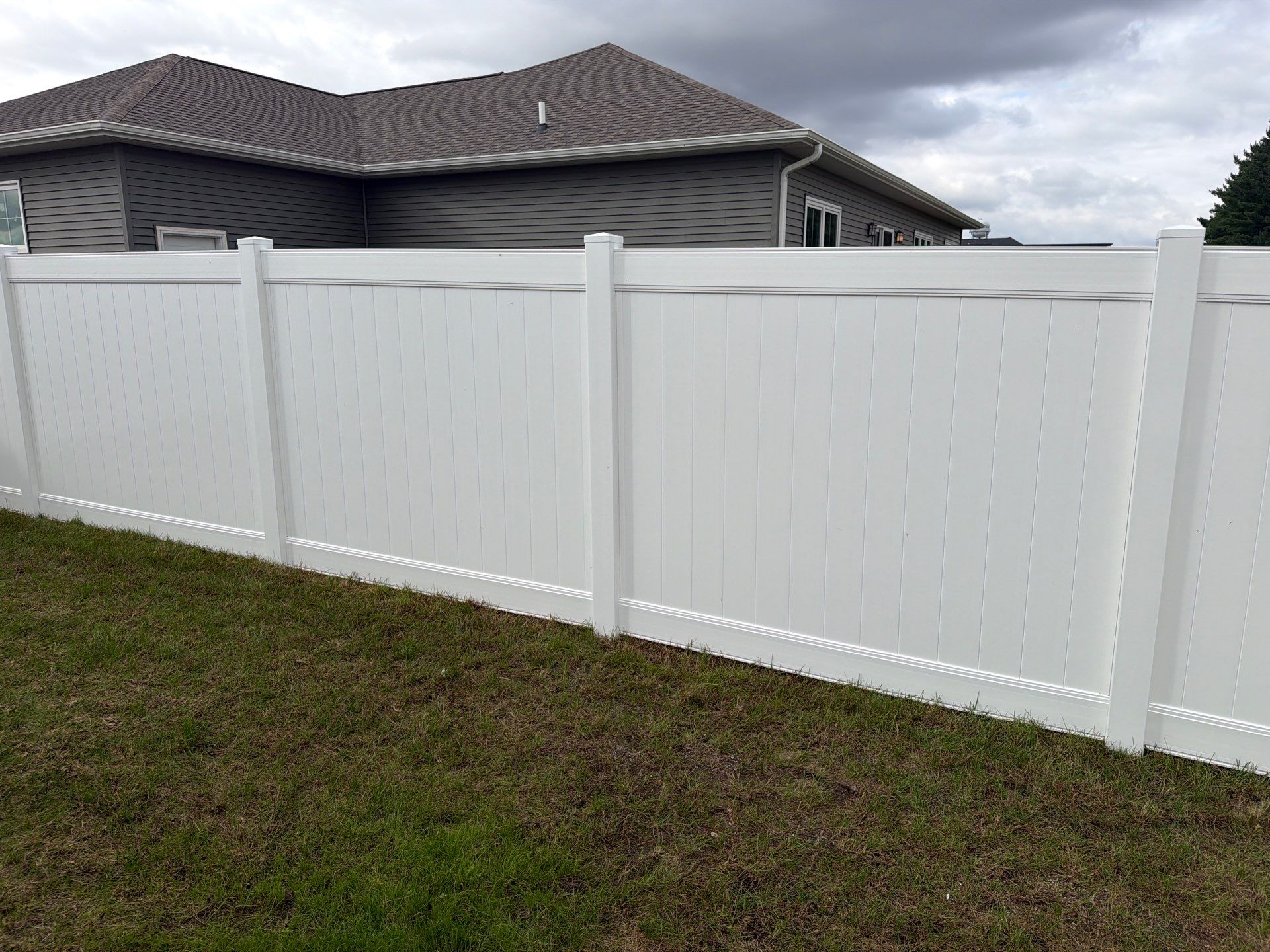 Residential White Vinyl Privacy Fence Installation in Janesville by Perfect Picket Fence and Stain