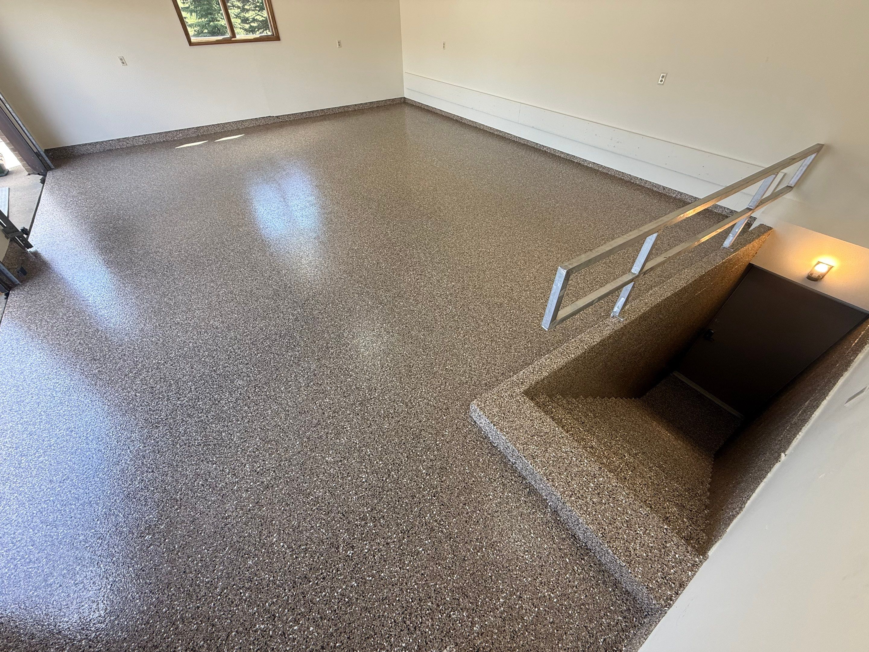 Custom Polyaspartic Garage Floor and Stairwell Coating in Pipestone by Select Painting, Coatings & Garage Cabinets