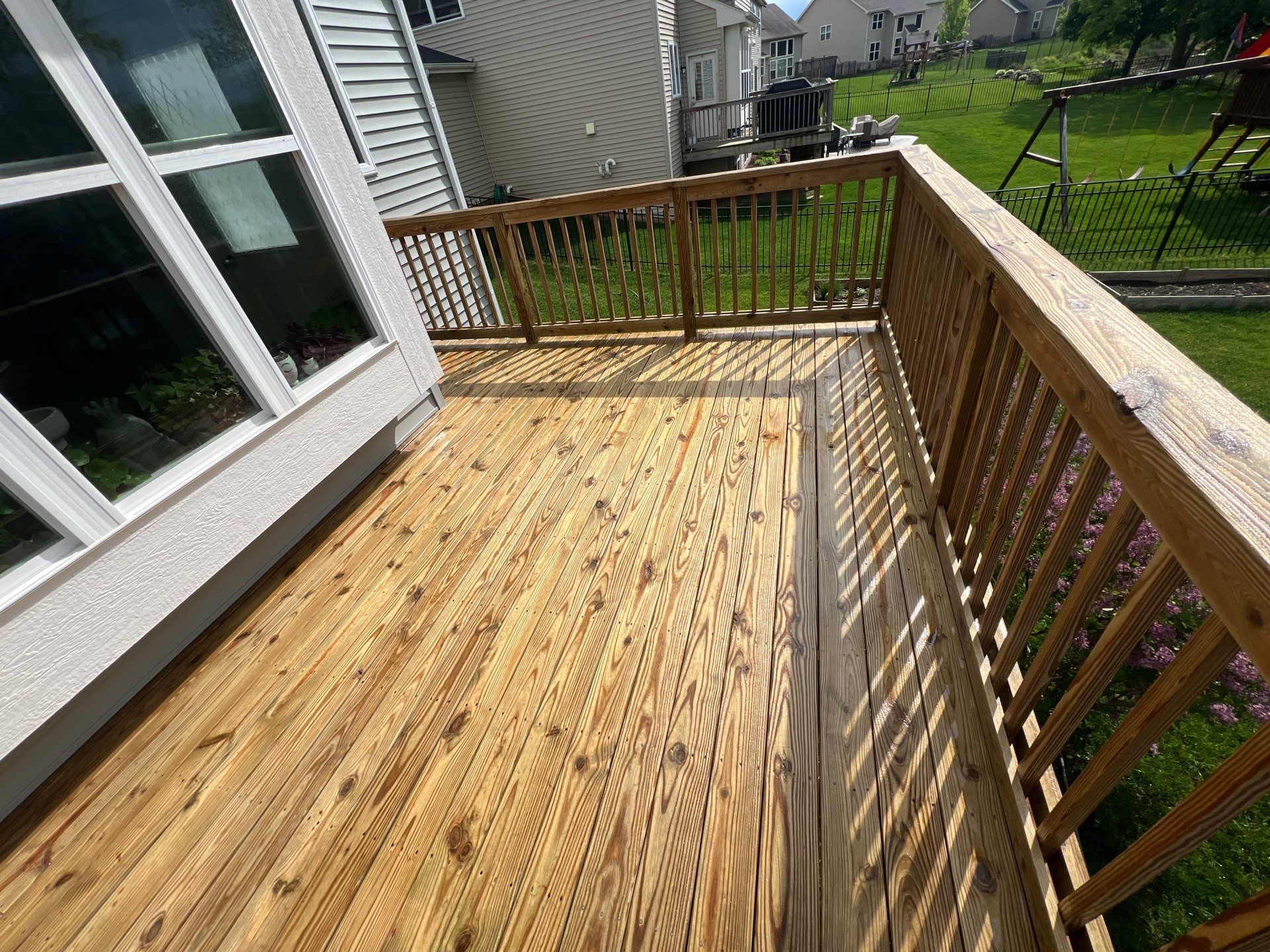 wood deck cleaning and staining by Northern Power Washing LLC.