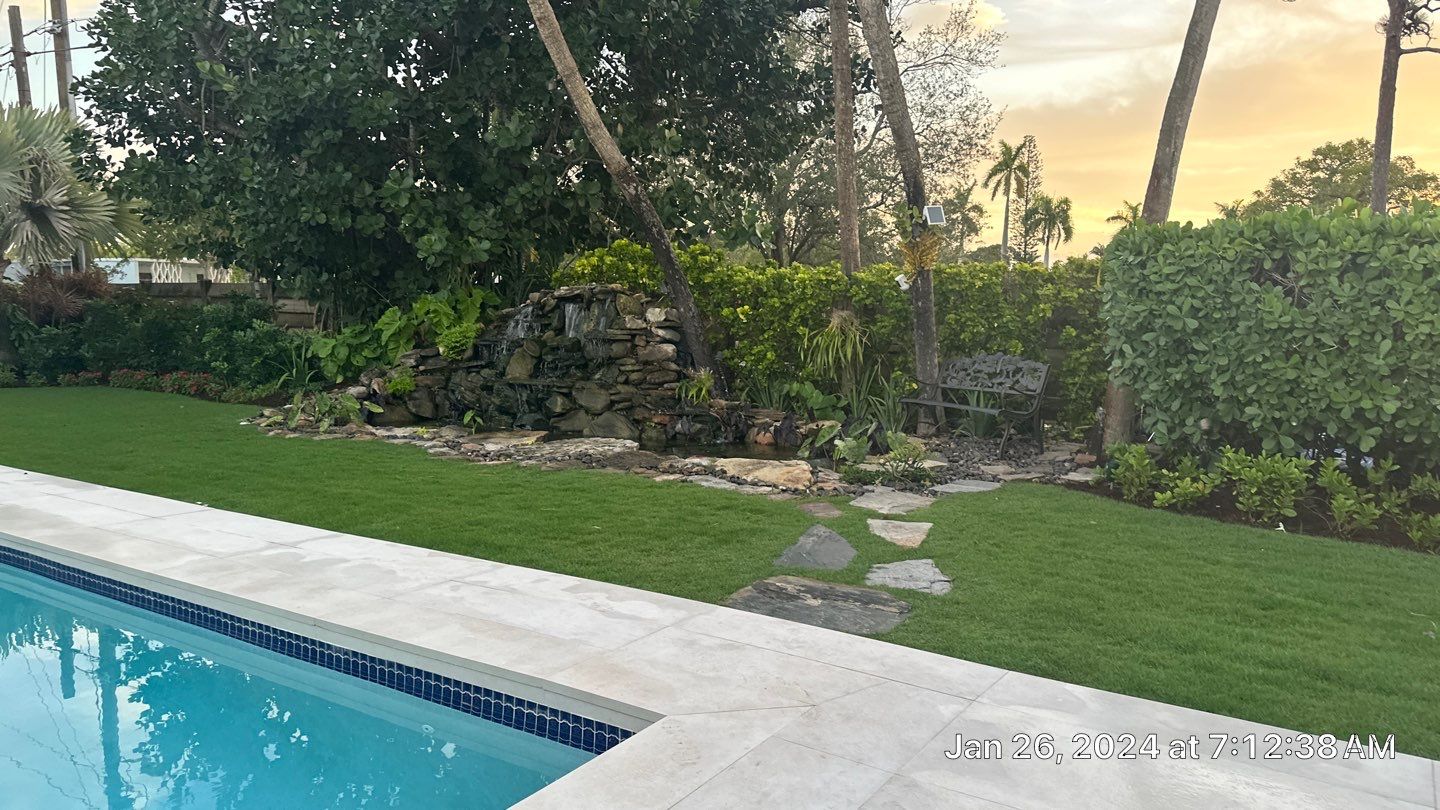 A Beautiful Relaxing Koi Pond with Waterfall in Pinecrest by Nature's Dream Landscape and Tree Service