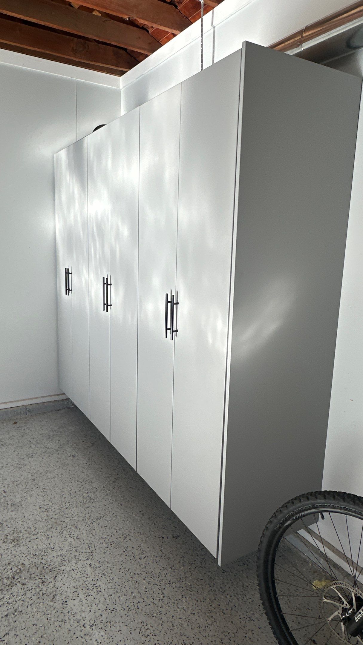 Jamie N added these beautiful cabinets for extra storage space by Banner Garage