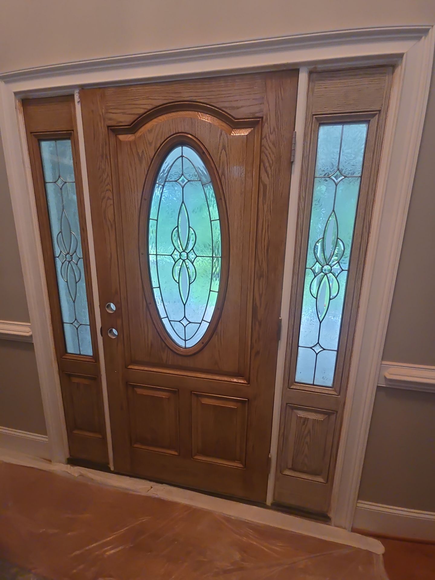 Siding replacement, exterior painting, and front door staining. by GonzalezPainters & Contractors Inc