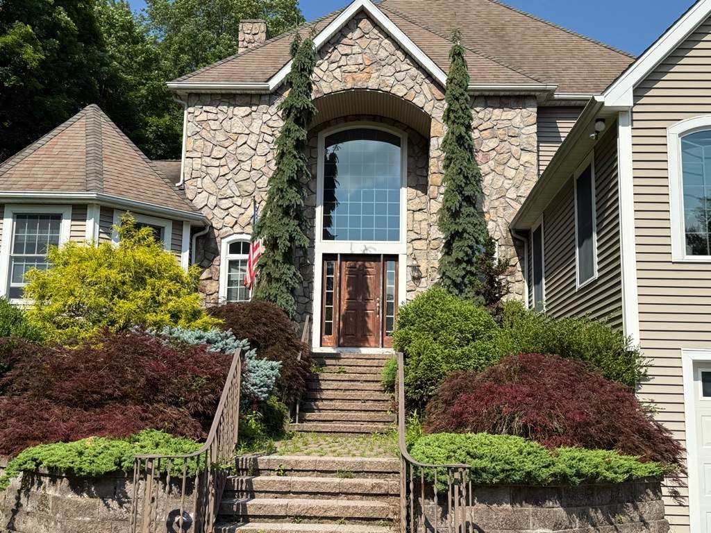 Bold Siding transformation with Cert Cedar Board & Batten S12, White, and Cert Monogram D/4 x 12'6" clapboard, Tuxedo by DiGiorgi Roofing and Siding Inc