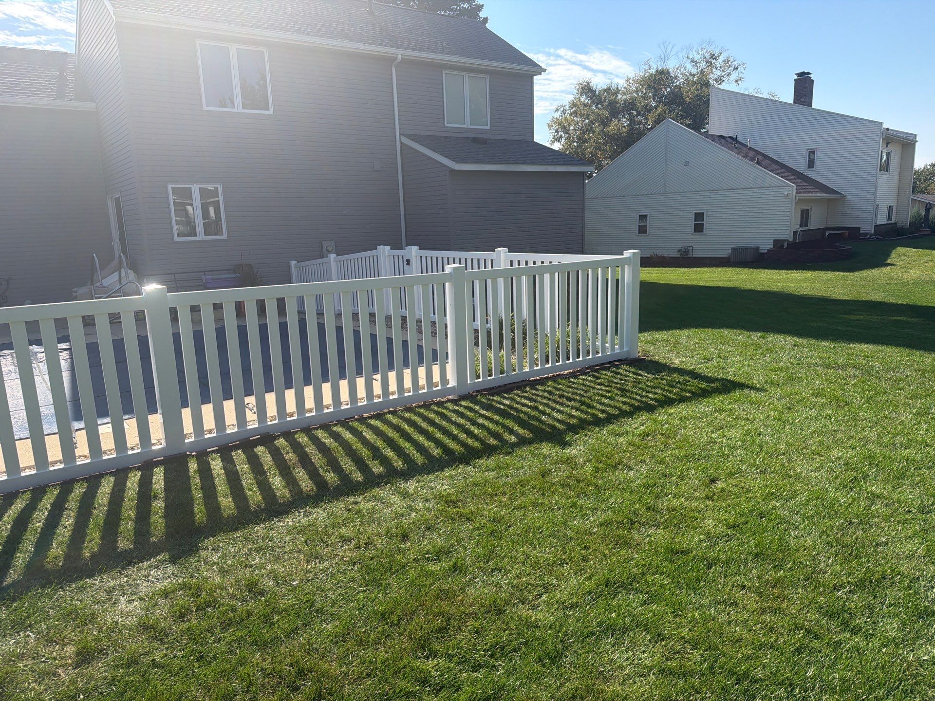 White Vinyl Picket Pool Fence Installation in Waterloo, Iowa by Perfect Picket Fence and Stain