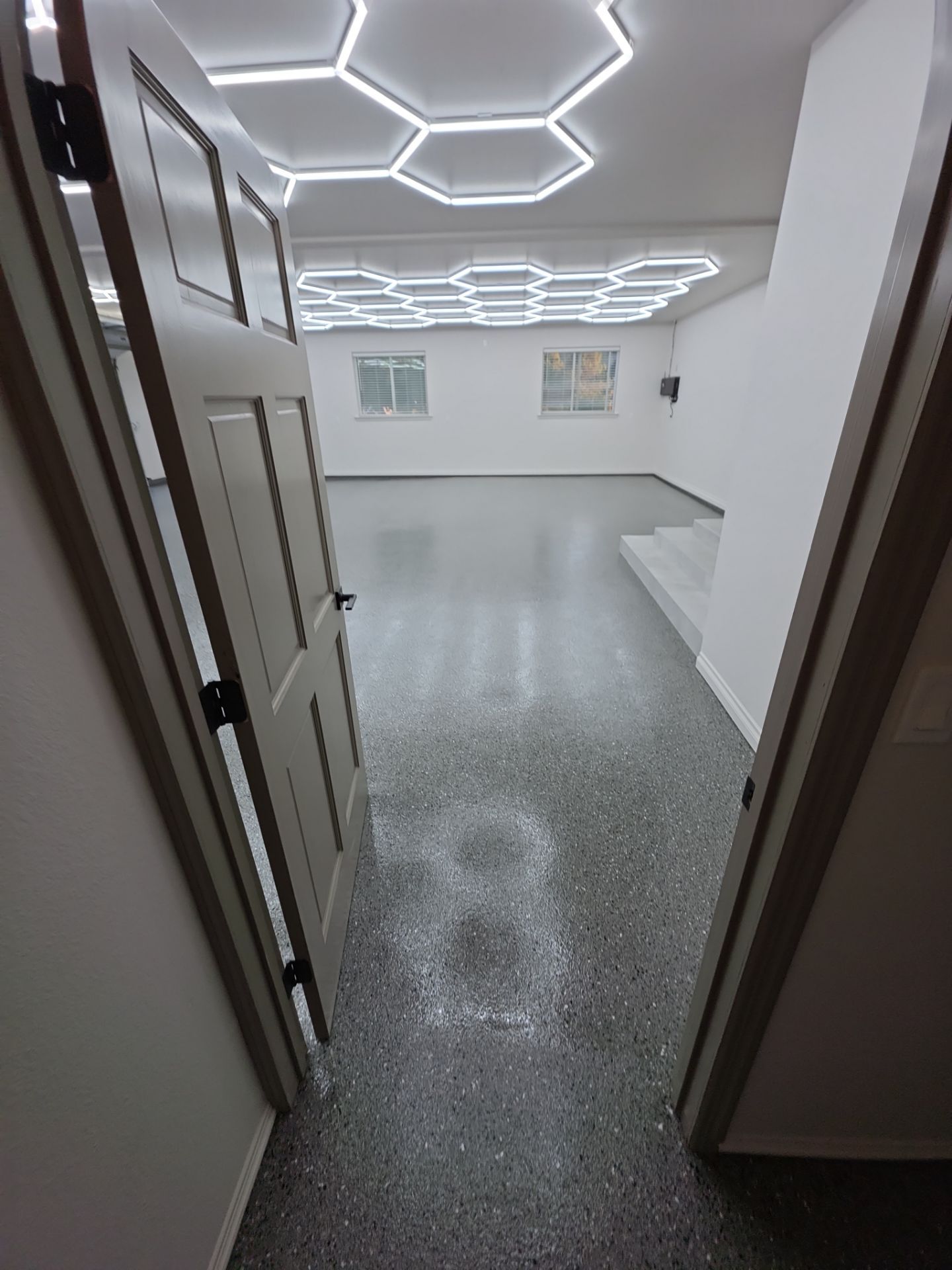 Custom Garage Transformation with Polyaspartic Coating and Hexagonal LED Lighting by Croc Coatings, LLC