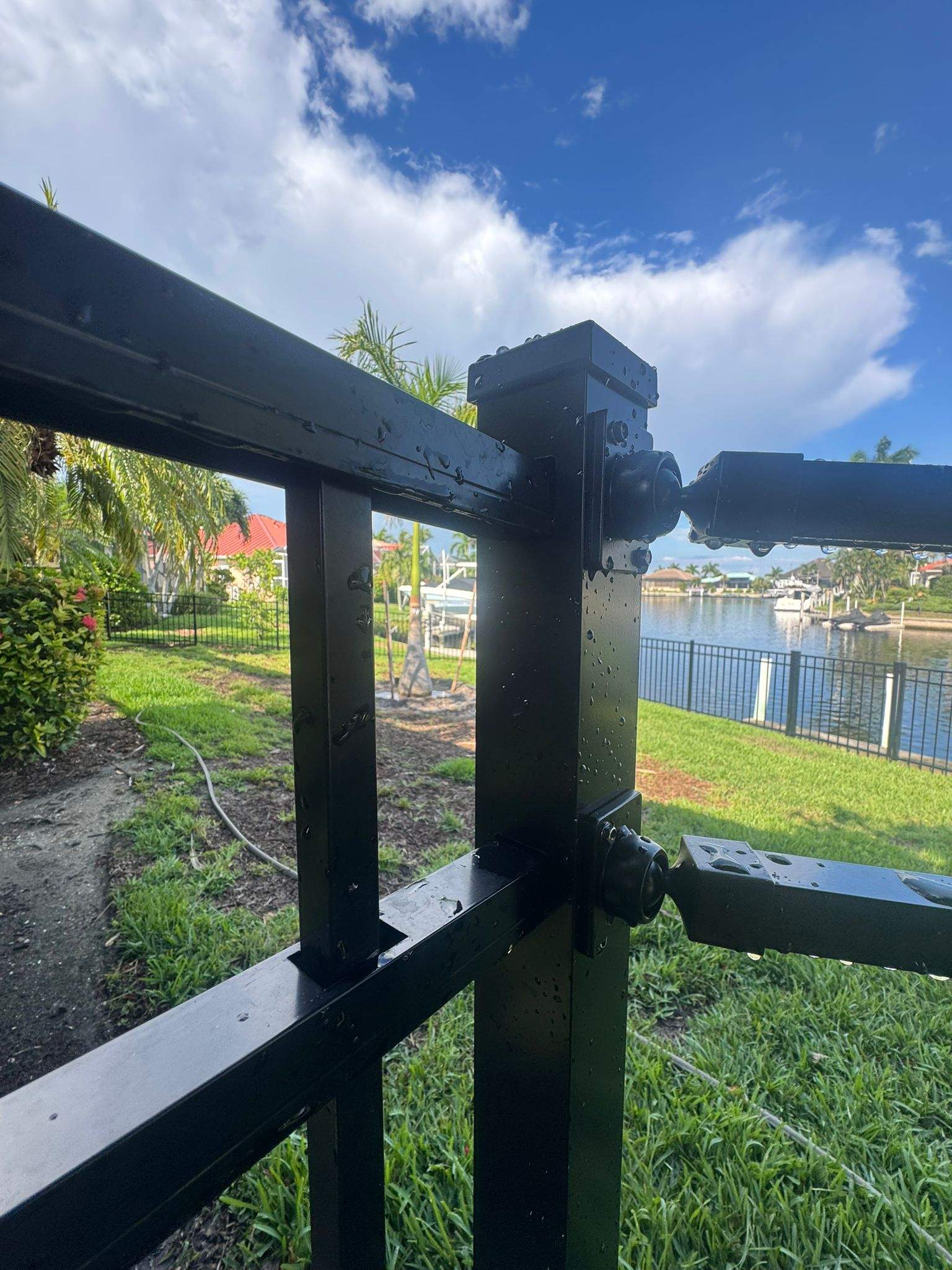 Black Aluminum Fence Installation Along Punta Gorda Canal by True Fence LLC