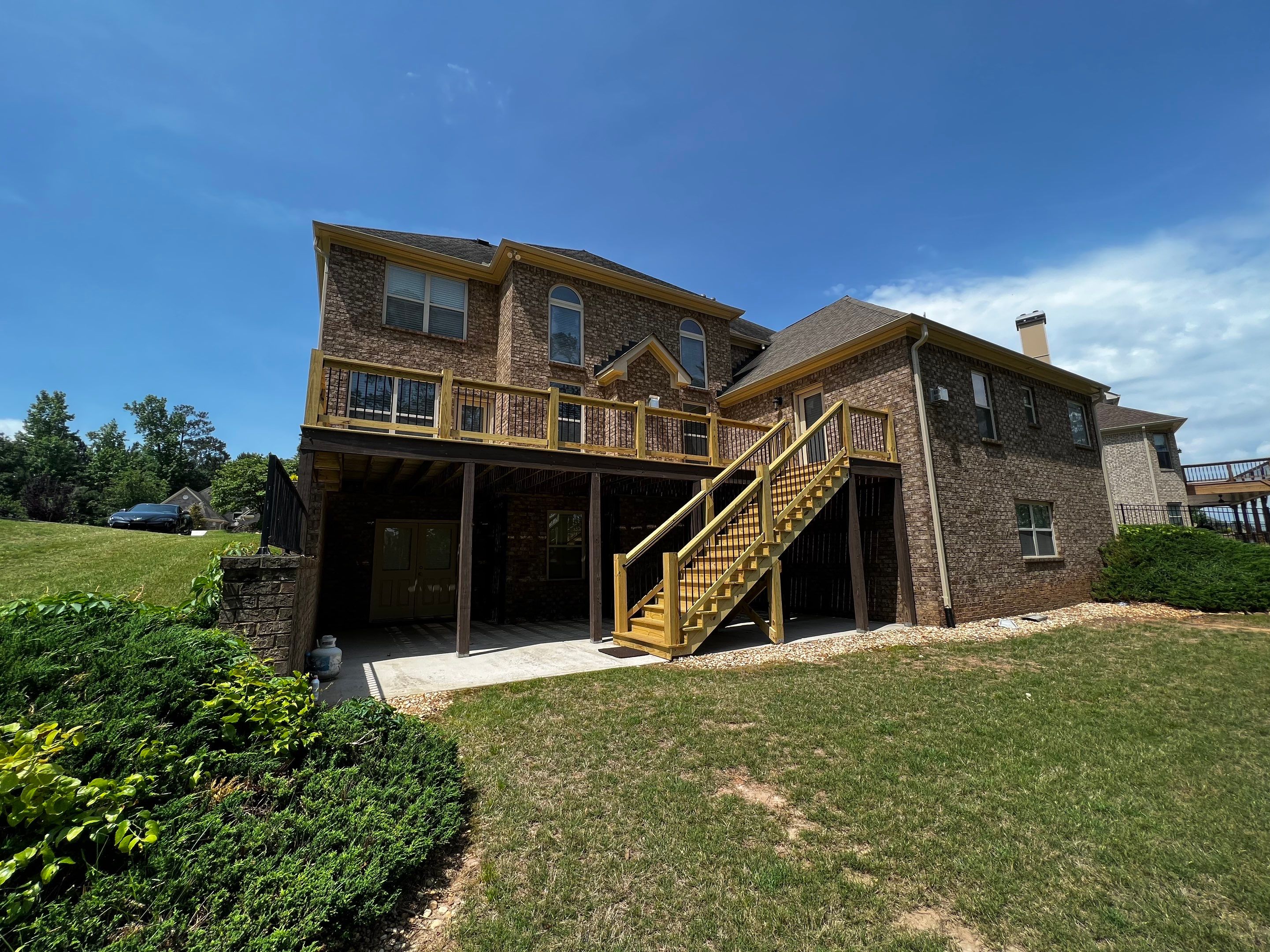 Elevated Pressure-Treated Wood Deck and Staircase in Hampton by Swift Home Renovations