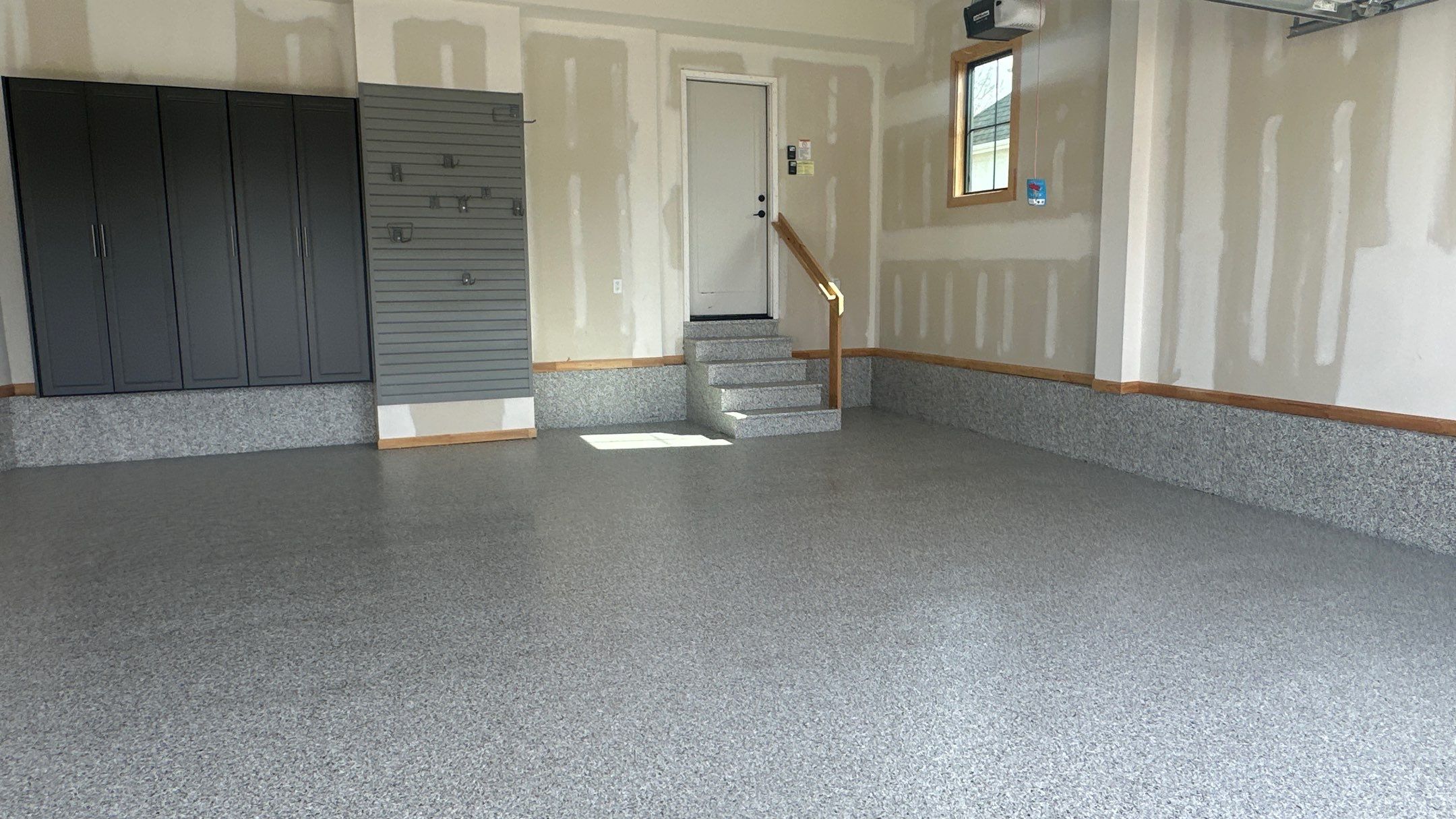 Megan J. added cabinets and slotwall to her garage. Plus a New Floor by Banner Garage