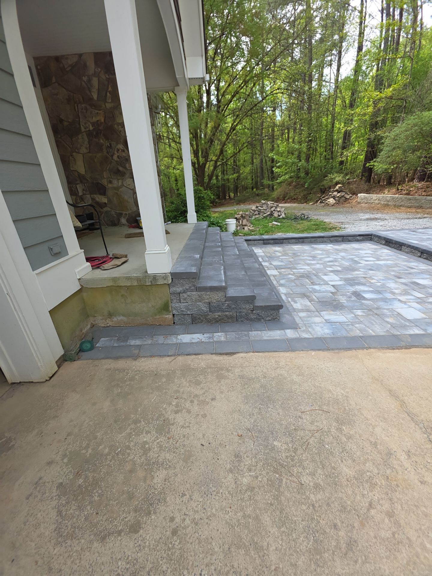 Pittsboro Outdoor Living Transformation – Retaining Wall, Paver Patio & Elevated Deck by Elite Remodeling and Design LLC