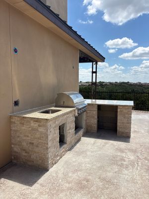 Custom Outdoor Kitchen and Stacked Stone Island in Helotes by Mena stone surfaces