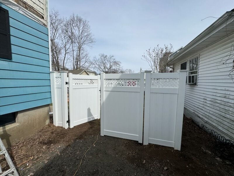 Fence install, White vinyl privacy fence with lattice accent. by DiGiorgi Roofing and Siding Inc