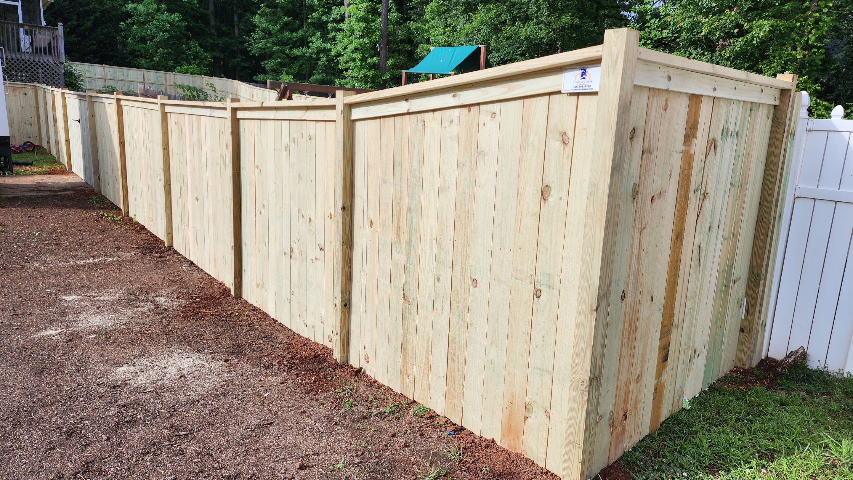 Fence Installation of Capped Wood Privacy Fence by Titans of Timber Fence & Stain