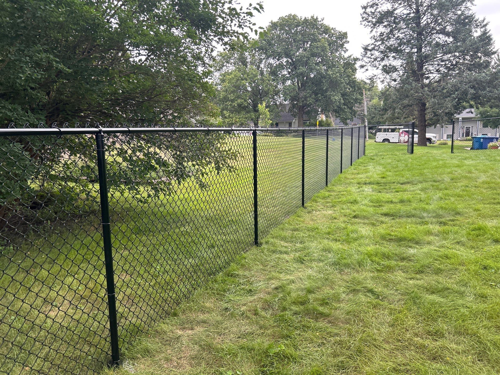 Black Vinyl Coated Chain Link Fence Installation in Waterloo by Perfect Picket Fence and Stain