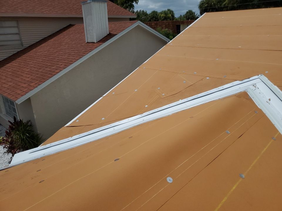 Residential Roofing Installation using 1.5" Nail Strip 24ga Solar White Kynar Coated Standing Seam Metal Panels by Morton Roofing, Inc.