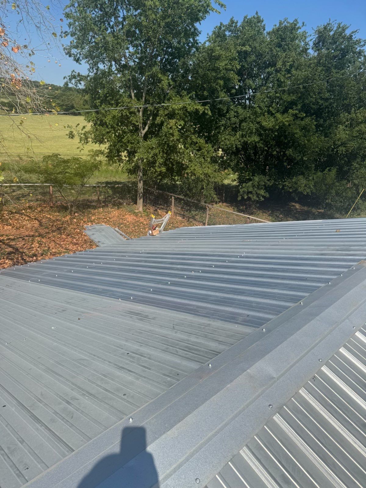 Corrugated Metal Roof Repair for Brick Home in Lindsay by BANA Roofing and Solar Supply