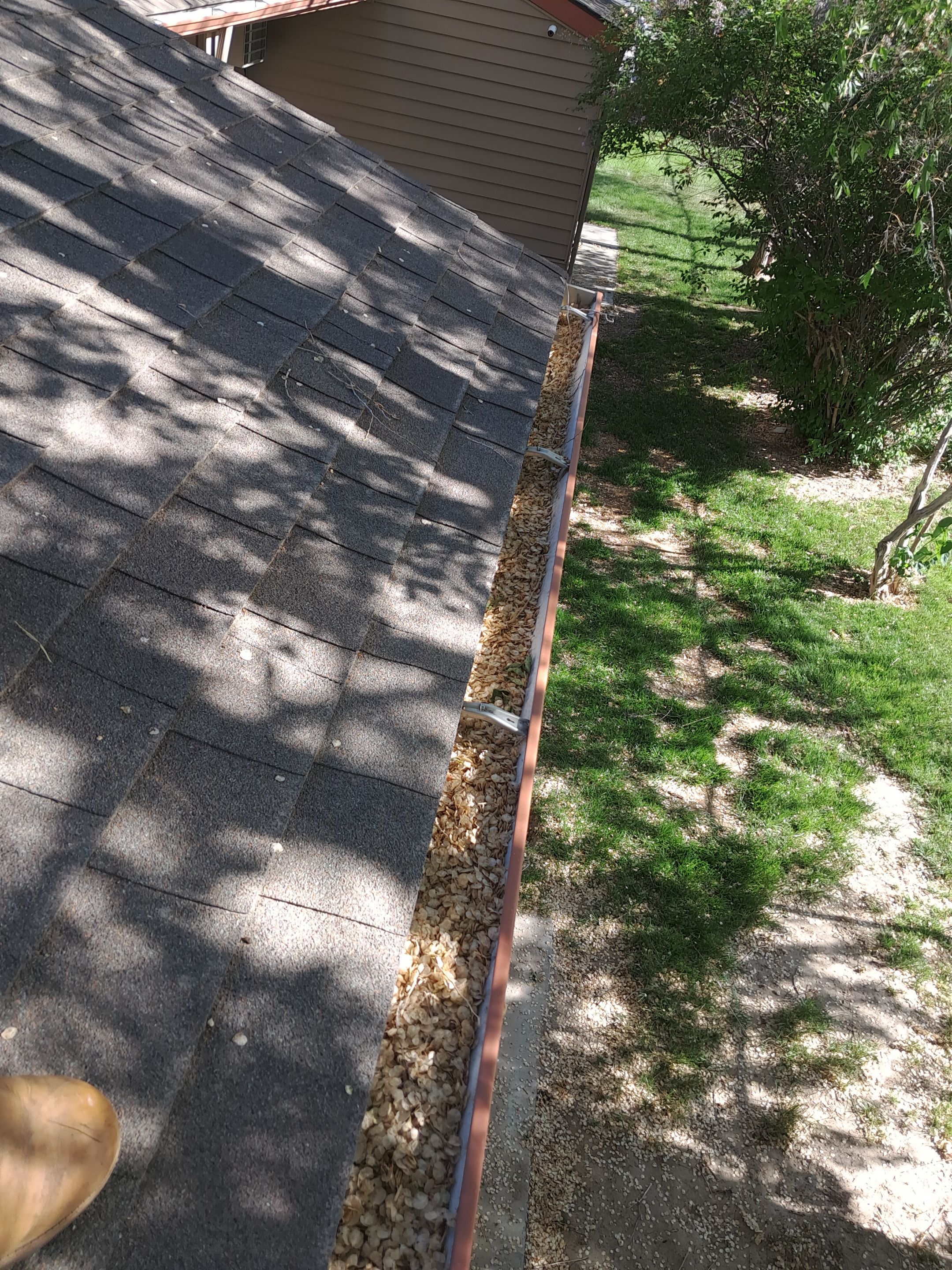 Commercial gutter cleaning Idaho before photo with filled gutters