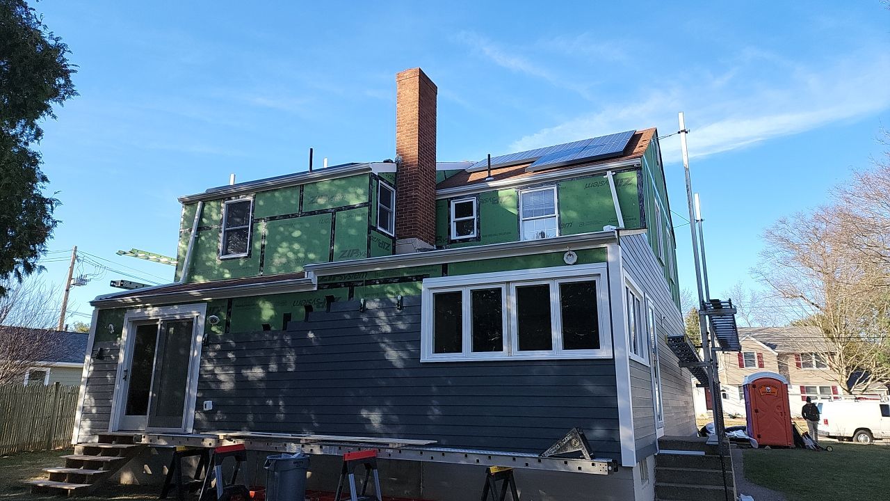 James Hardie siding, new metal roof and couple windows being installed. by UBrothers Construction