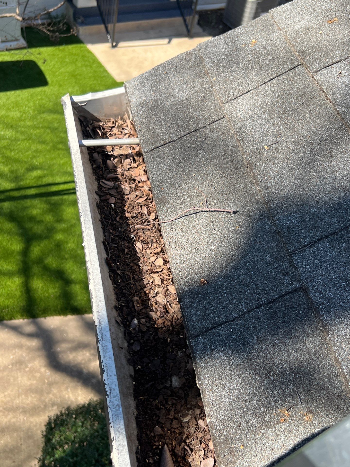 Commercial gutter cleaning Carrollton, TX before photo with filled gutters