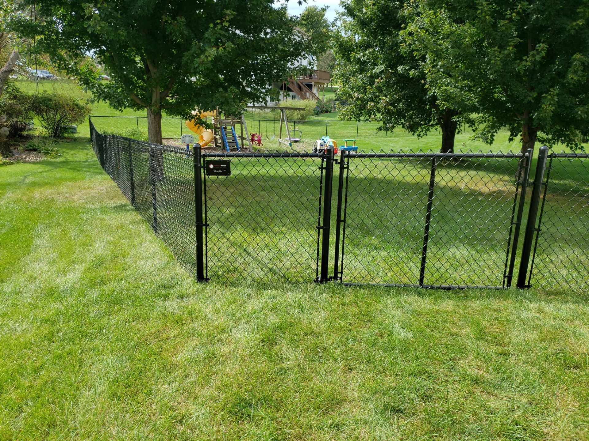 Black Vinyl-Coated Chain Link Fence Installation in Cedar Falls by Perfect Picket Fence and Stain