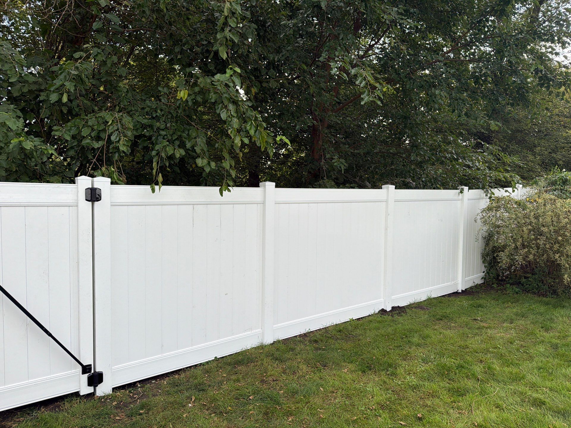 White Vinyl Privacy Fence Installation in Raymond, IA by Perfect Picket Fence and Stain