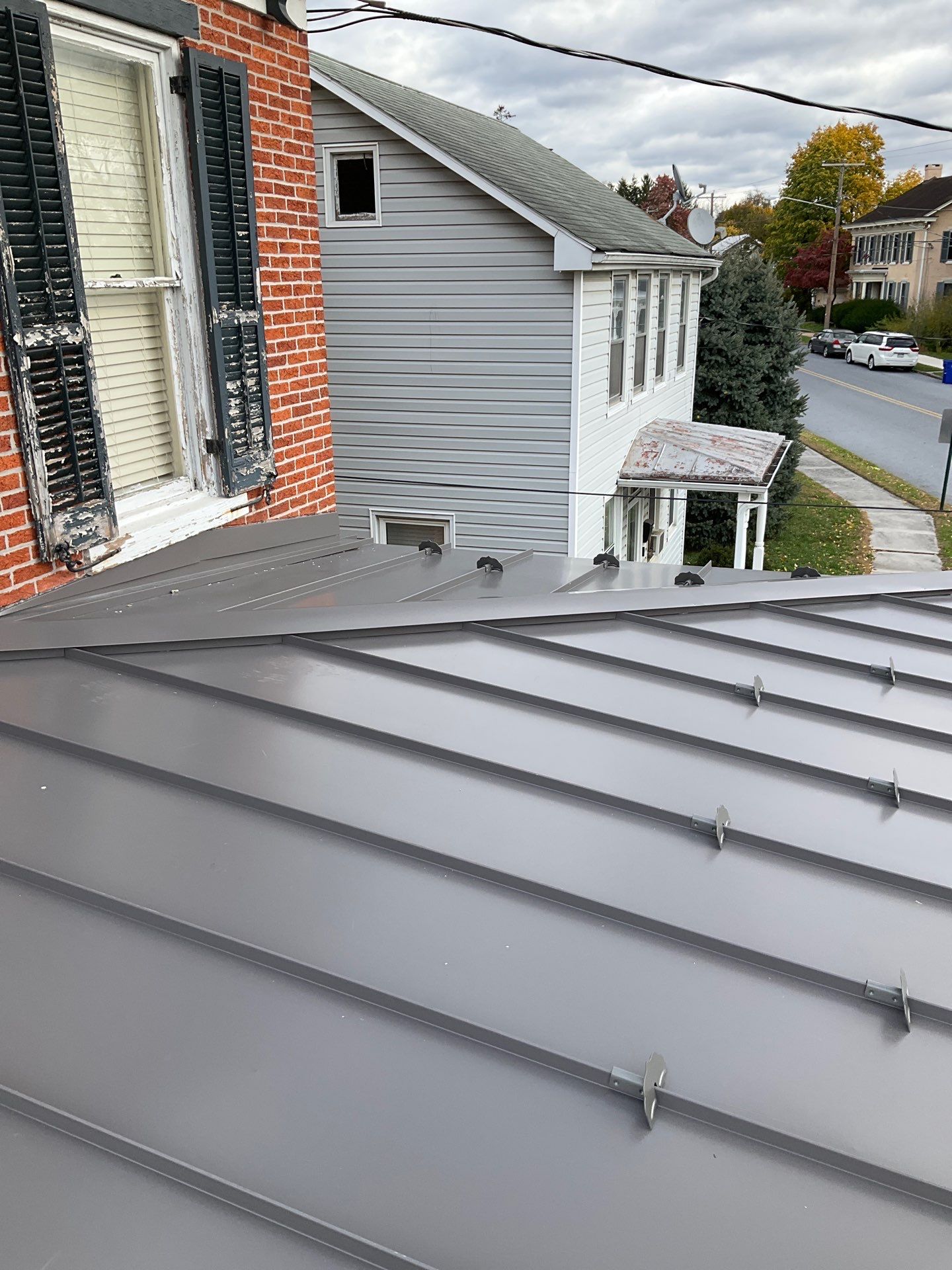 Updated Porch Roof with Clean Standing Seam Lines by Esh Builders