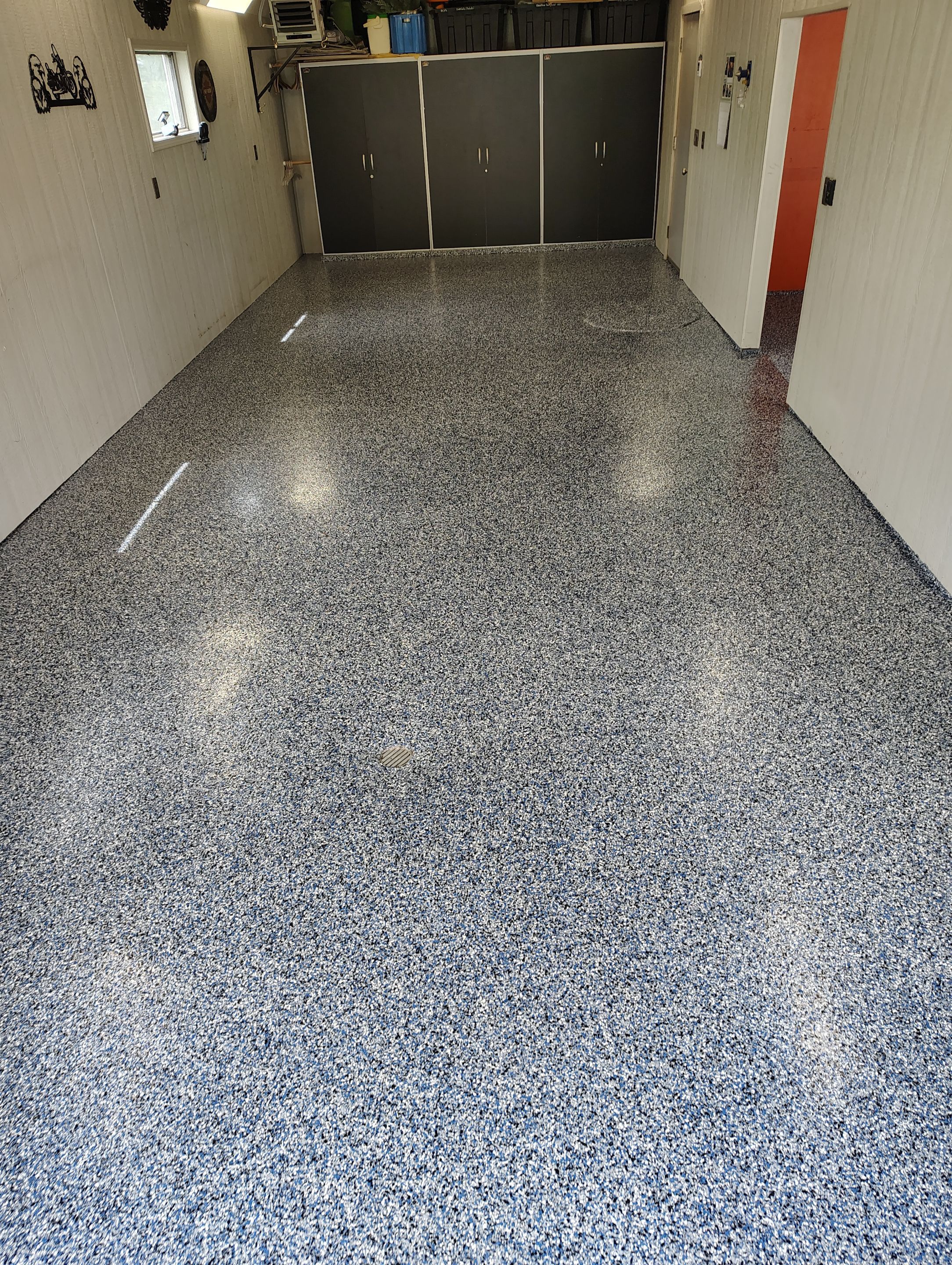 Custom Grey Flake Epoxy Garage Floor Installation in Remsen by Select Painting, Coatings & Garage Cabinets