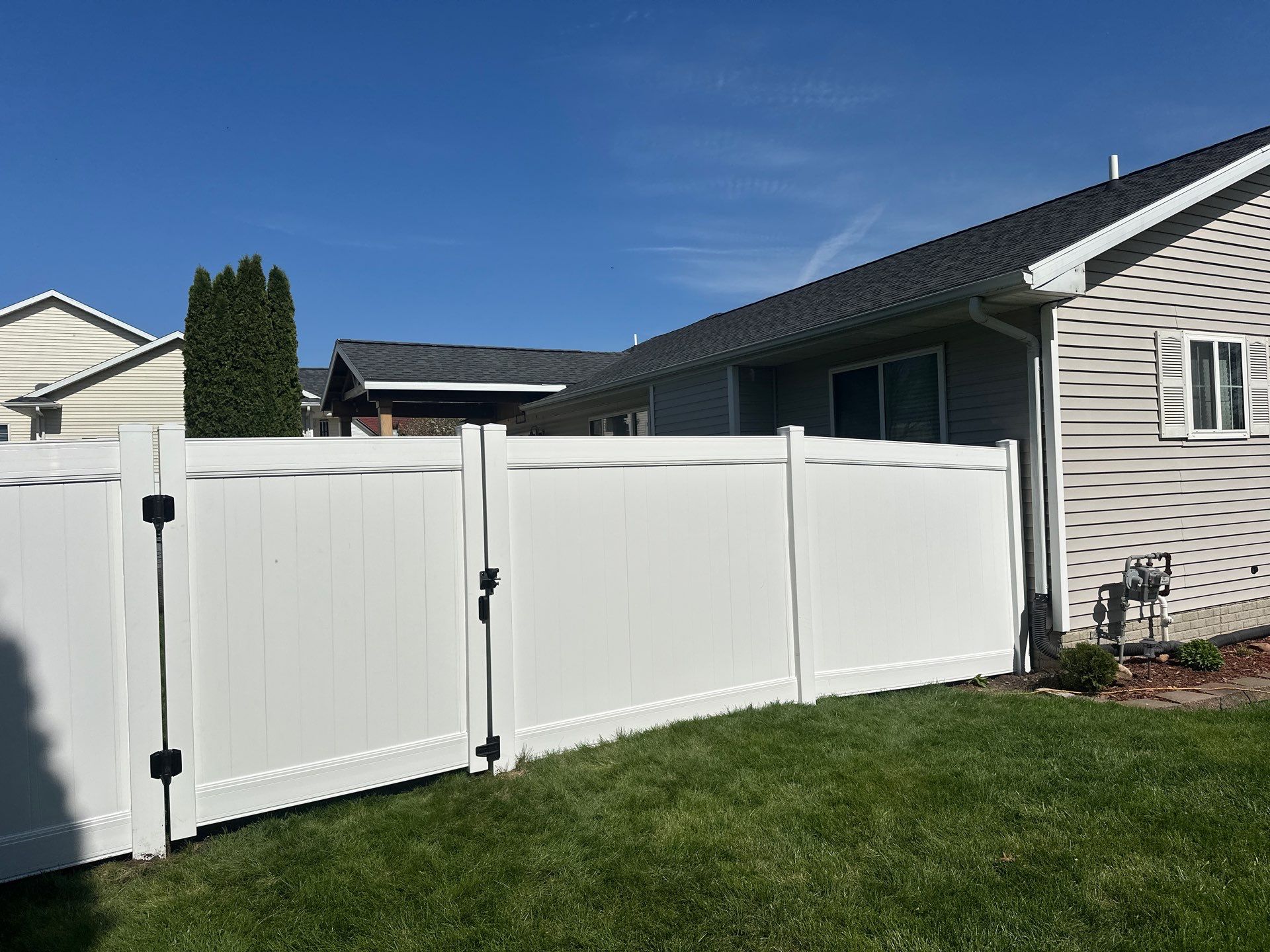 White Vinyl Privacy Fence Installation in Raymond, Iowa by Perfect Picket Fence and Stain