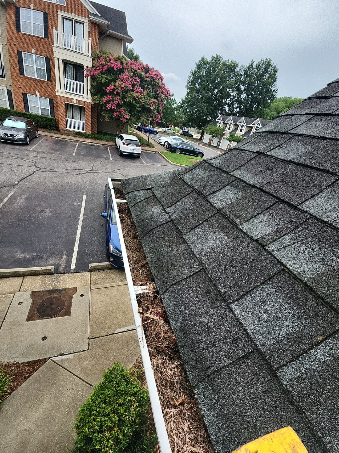 Commercial gutter cleaning Norfolk, VA before photo with filled gutters