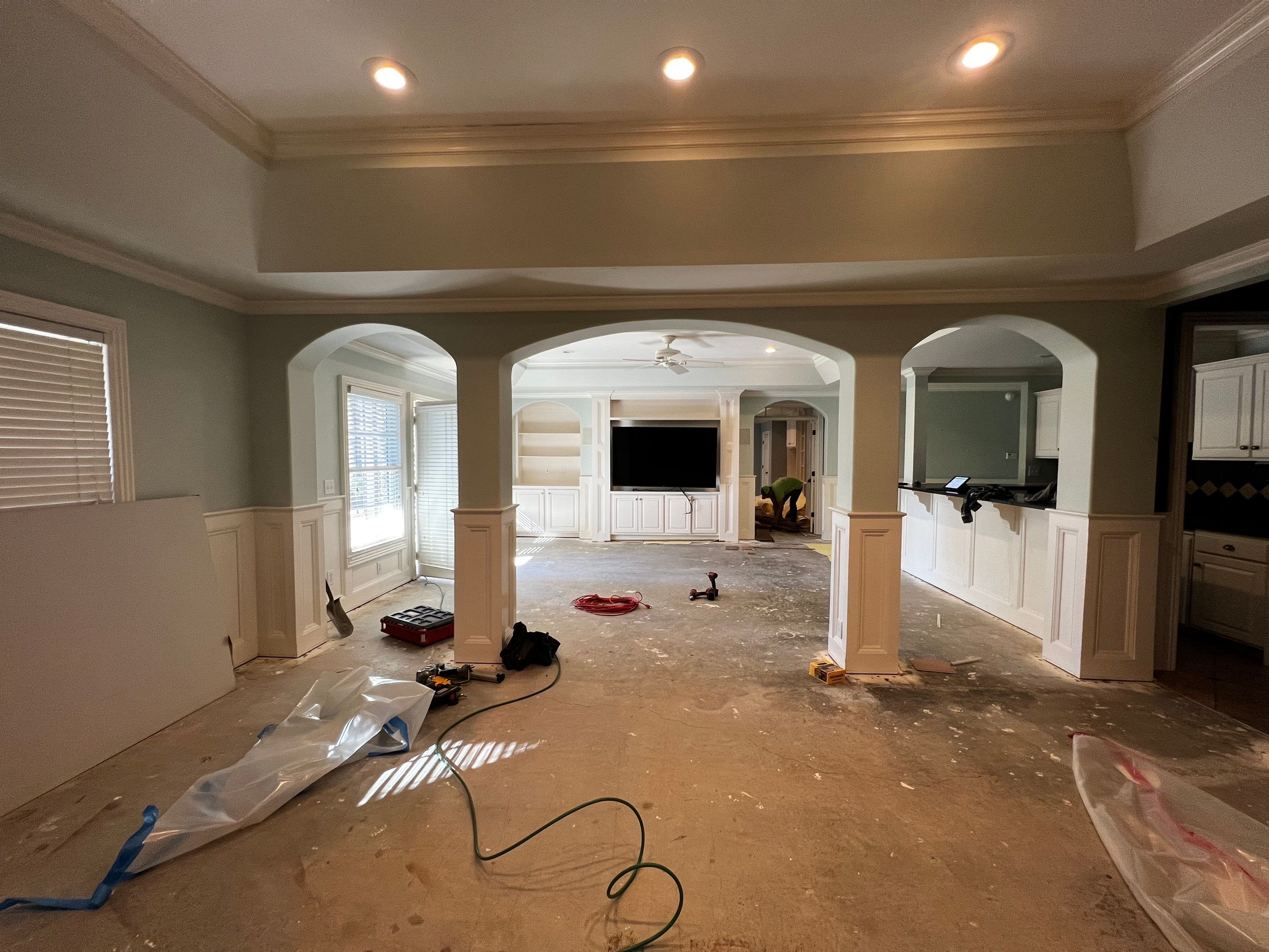 Finished Basement Remodeling with Dark Wood-Look Flooring and Custom Wainscoting by Swift Home Renovations 
