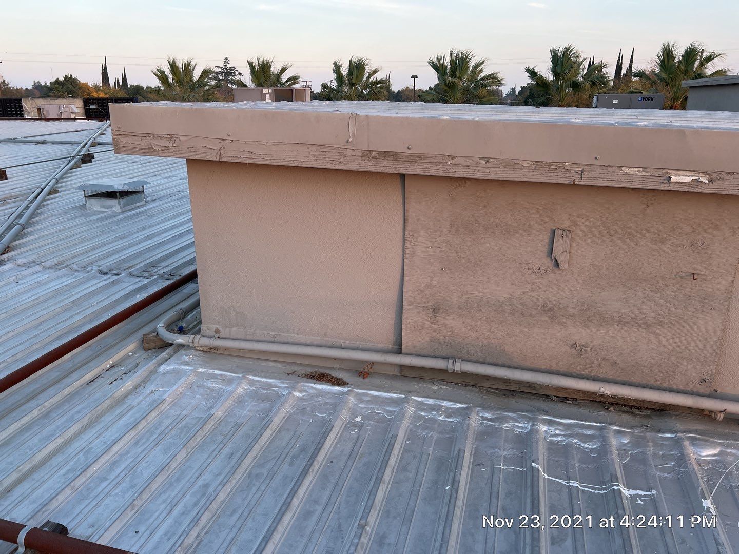 Metal roof restoration on commercial roof using Conklin Benchmark/ PUMA XL acrylic coatings over metal and foam by Straight Edge Roofing Inc