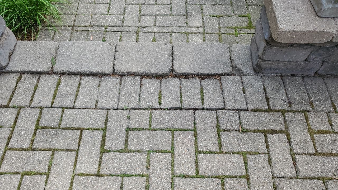 Brick patio repair, clean sand and seal by Northern Power Washing LLC.