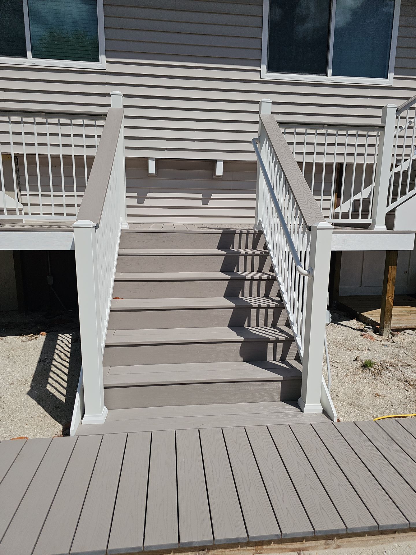 Elevated Composite Deck and Symmetrical Staircase Replacement in Englewood by Smirnov Construction Inc