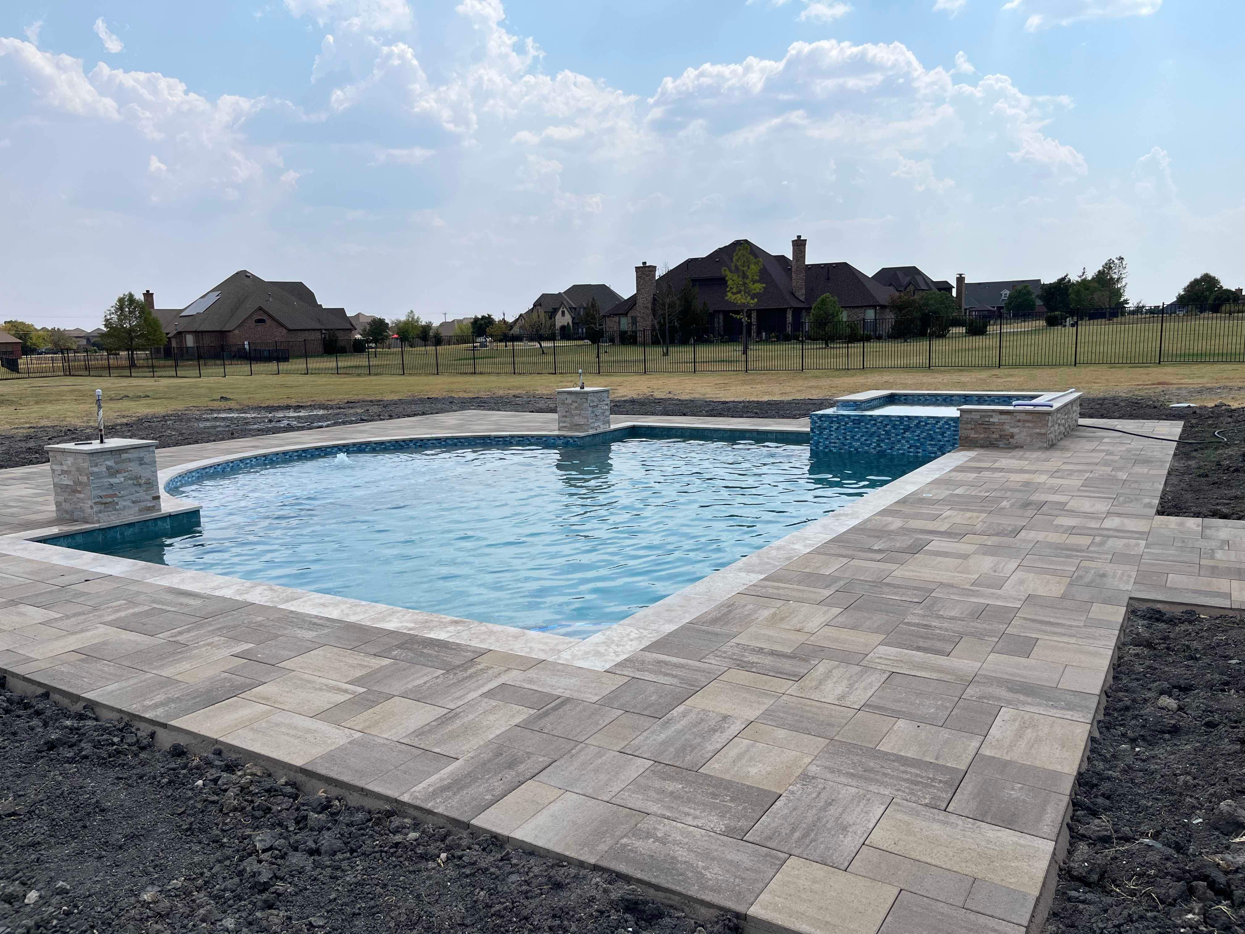 Freeform Pool and Spa with Travertine Decking and Bubblers by Pinnacle Pools and Spas - DFW