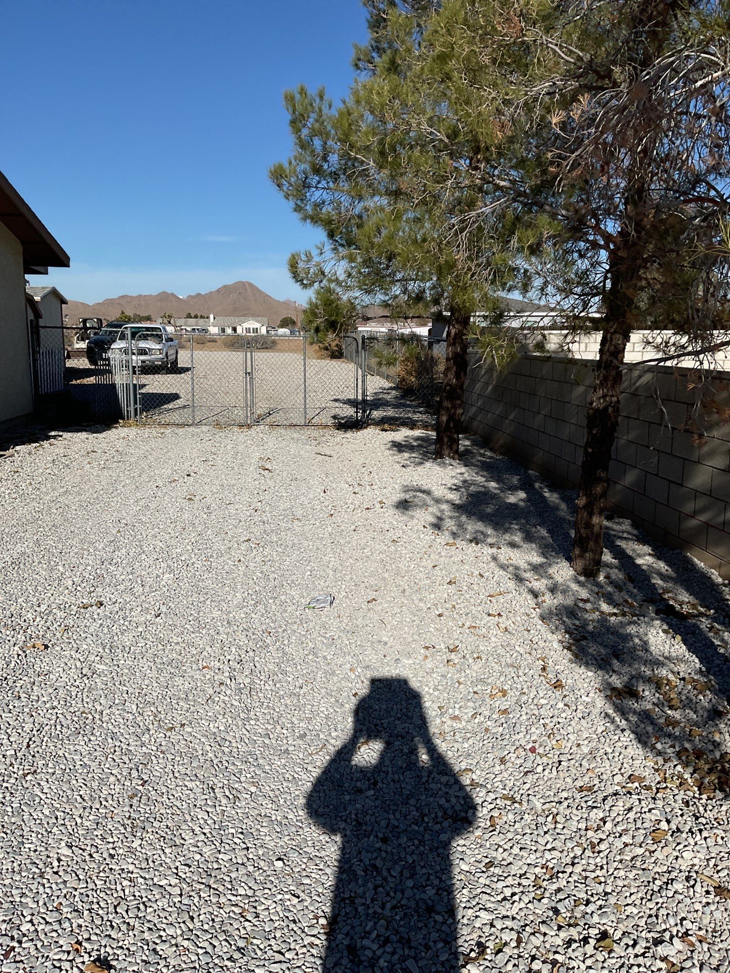 Sleek chain link fence installation with a solar motorized gate by Fence Guys Inc.