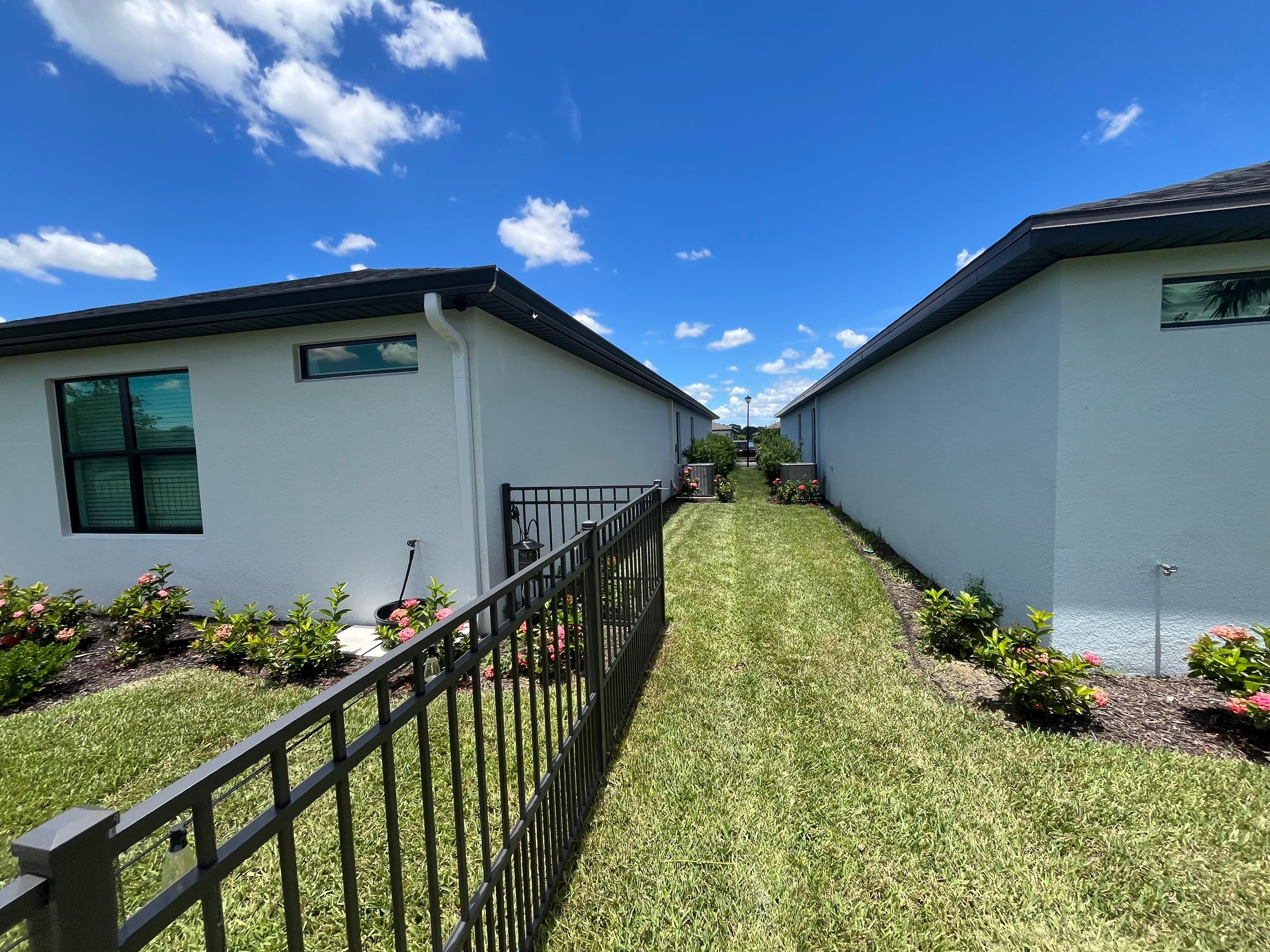 Dark Bronze Gutters and White Downspouts in Sarasota FL by Gutter Professors