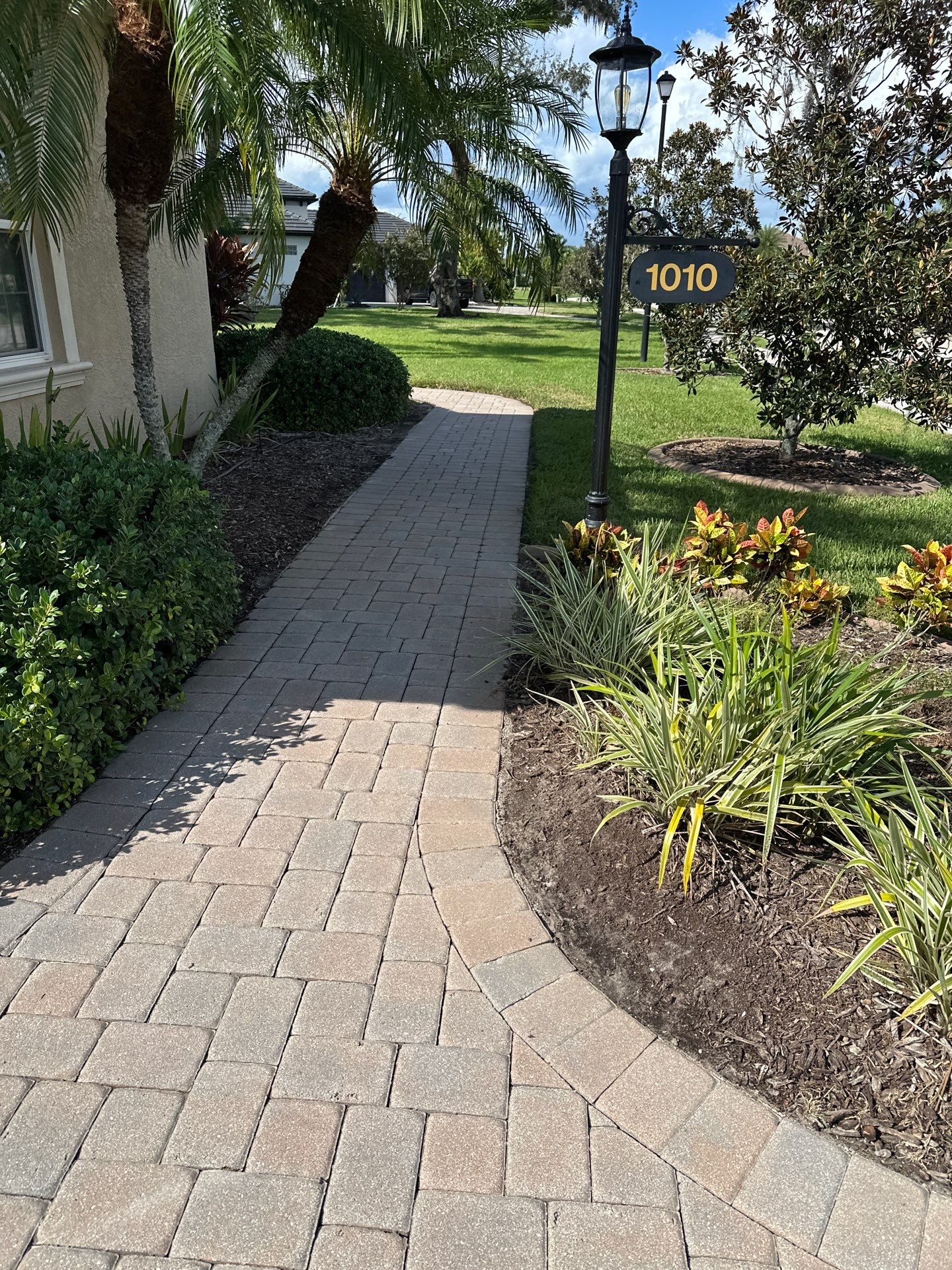 Paver Driveway, Entryway, Sidewalk, and Street Curbing Cleaning in Winding River Community, Bradenton, FL by Sunshine AquaWash